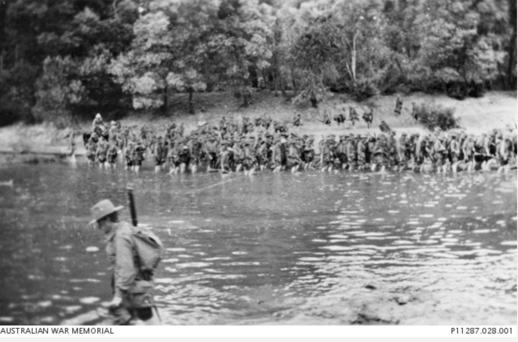 Men of 18th Battalion march through a ford