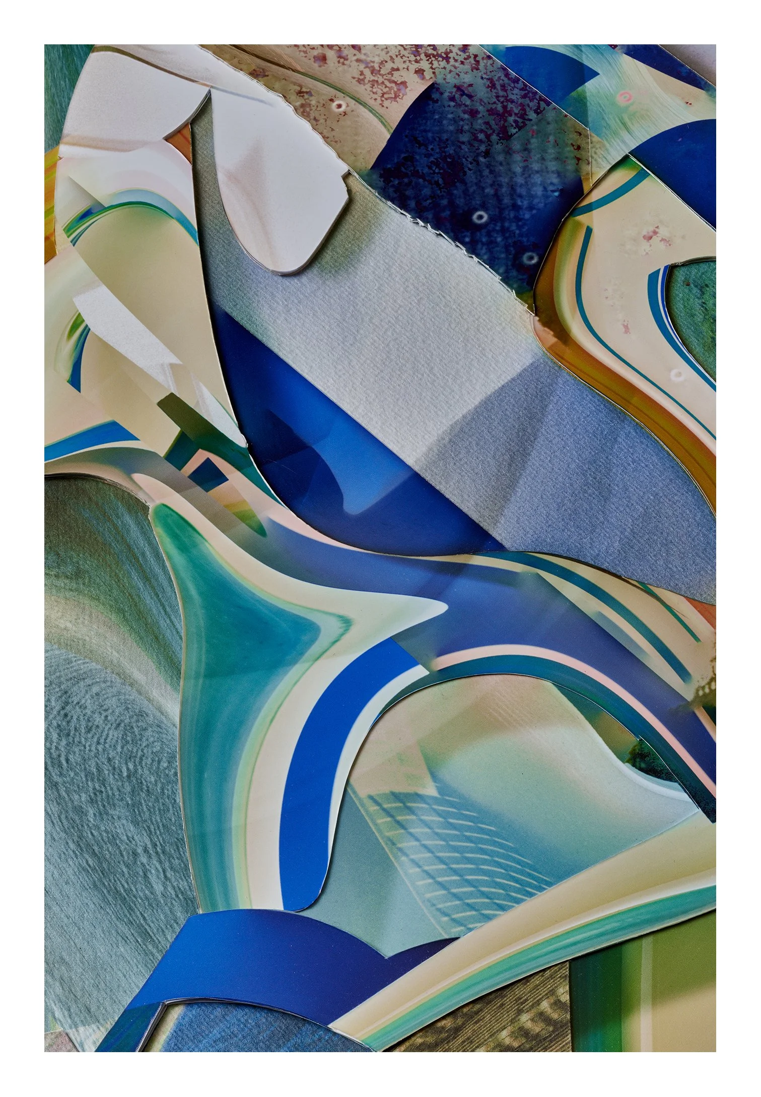Colorful curved architectural structure with white, blue, green, and beige sections and textured surfaces, seen from an angled perspective.