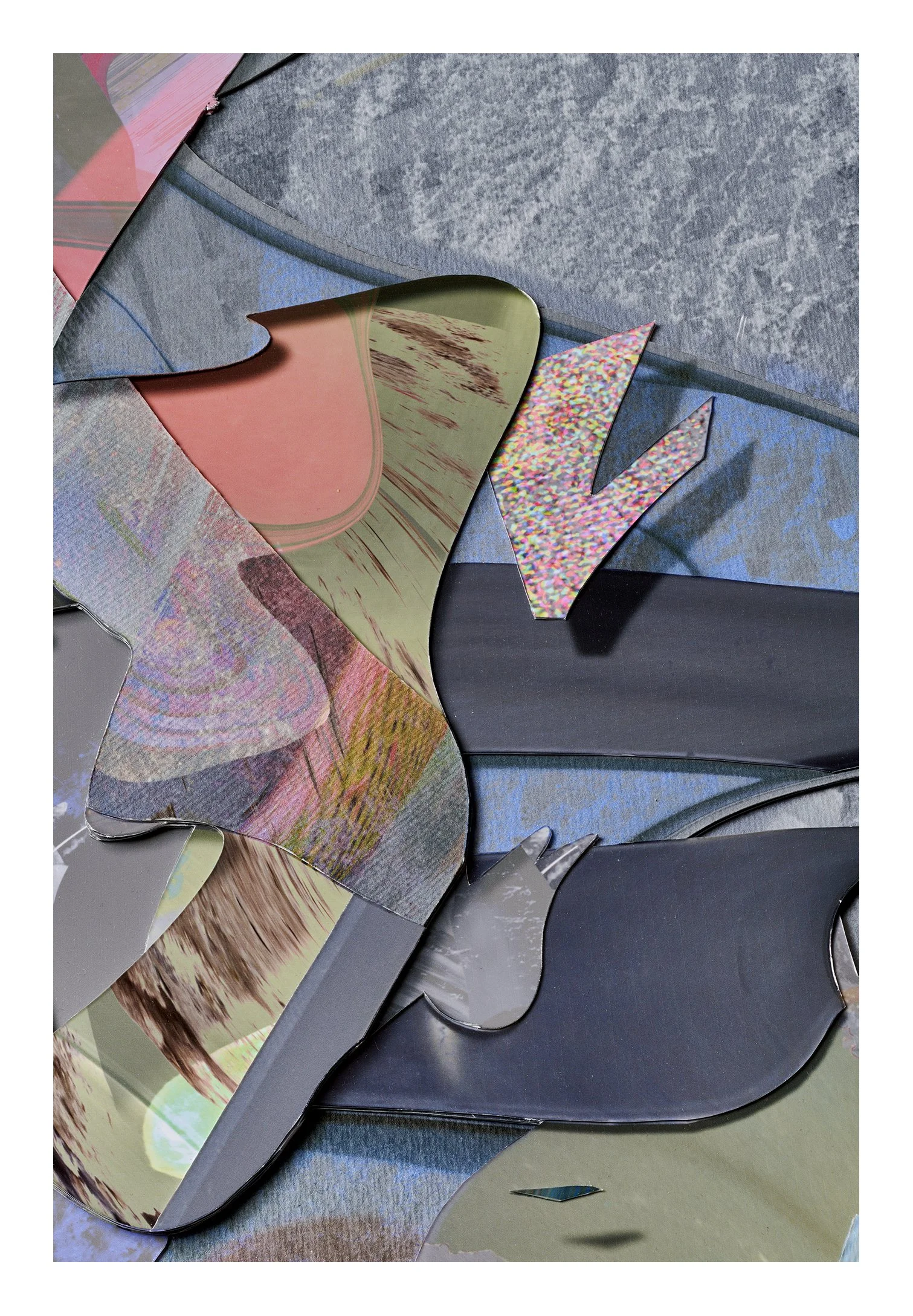 Broken metallic and paper pieces with colorful patterns and textures scattered on a surface.