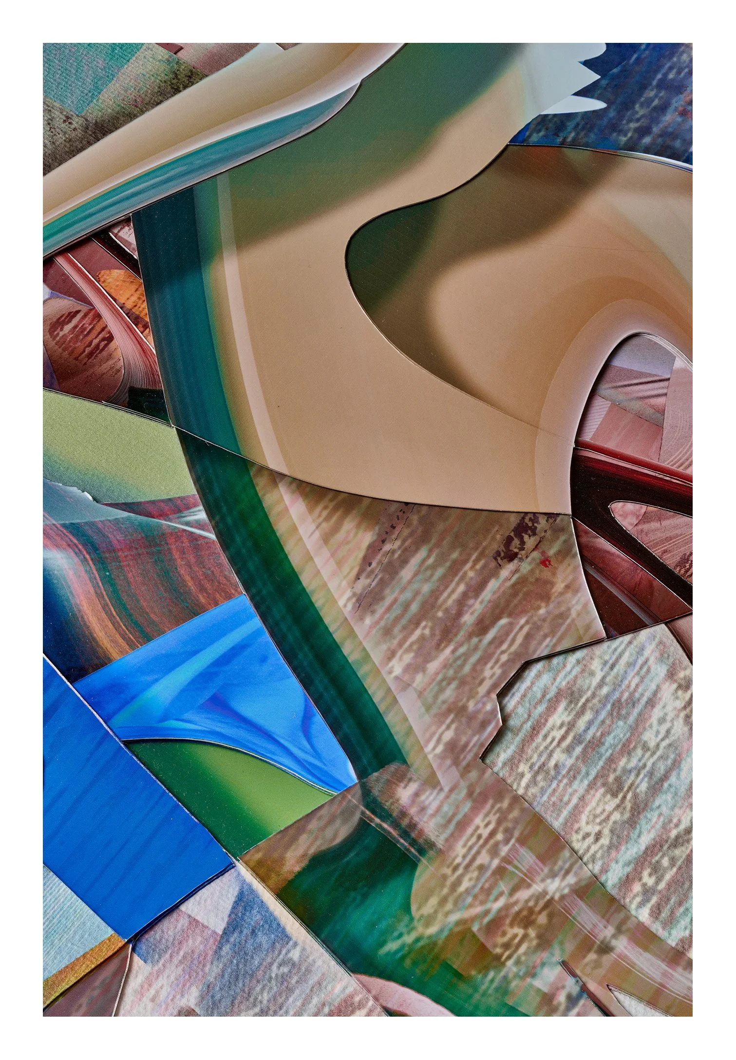 Close-up of colorful, glossy magazines or posters with various curved and abstract shapes and patterns.