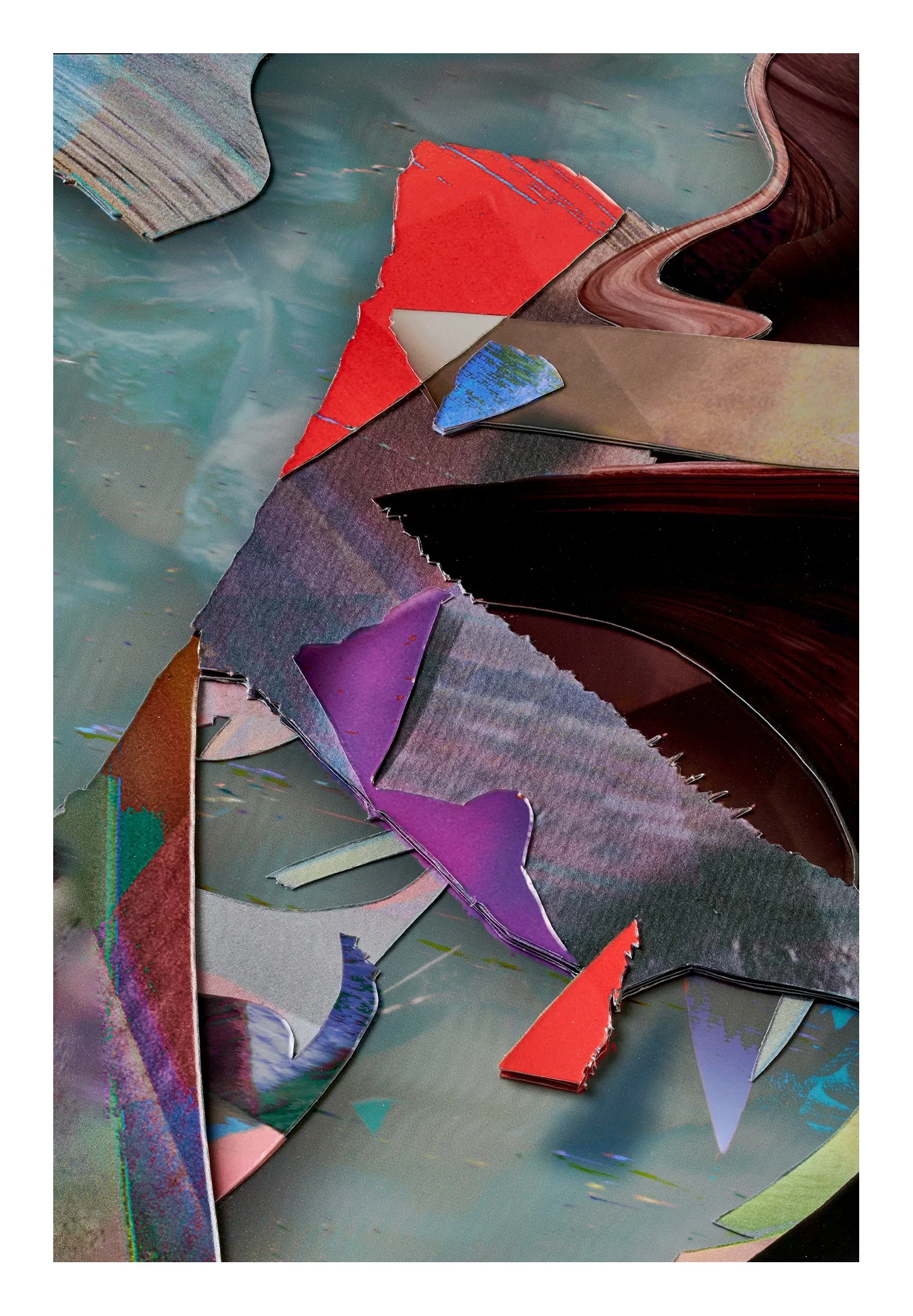Close-up of torn and layered colorful paper or cardboard with various textures and colors, including red, purple, brown, and metallic sheets, on a surface.