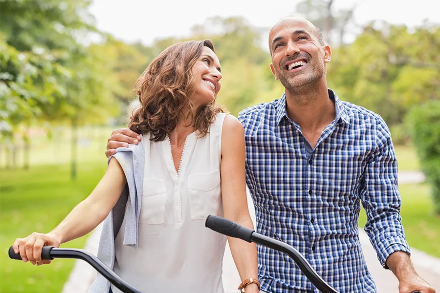 couple smiling and riding bikes together