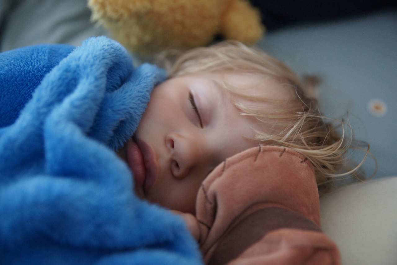 Gus sleeping with his Woody doll.