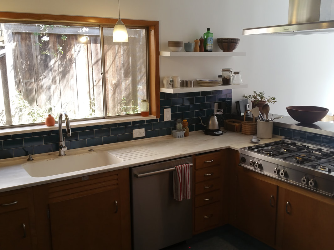  Floating shelves, modern style range  & new back splash give this kitchen a much needed facelift 