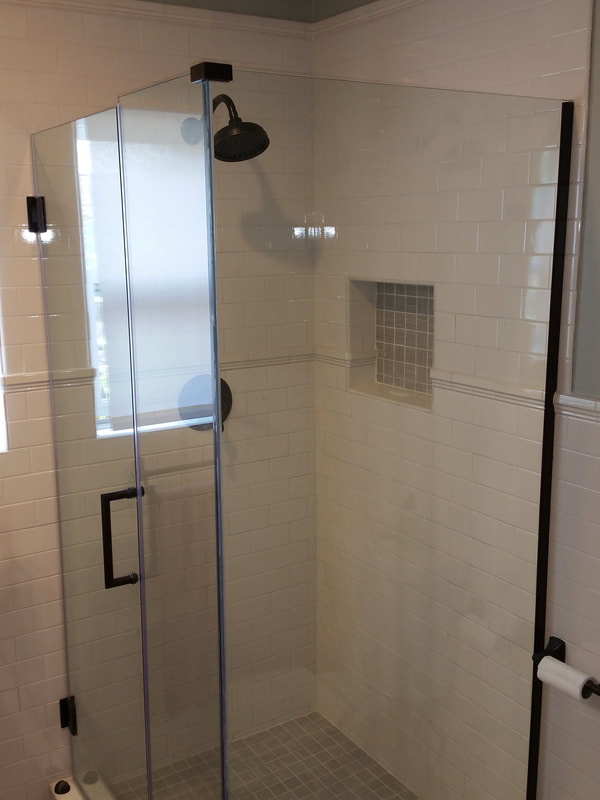  Frame-less shower walls show off the tile surround.
 