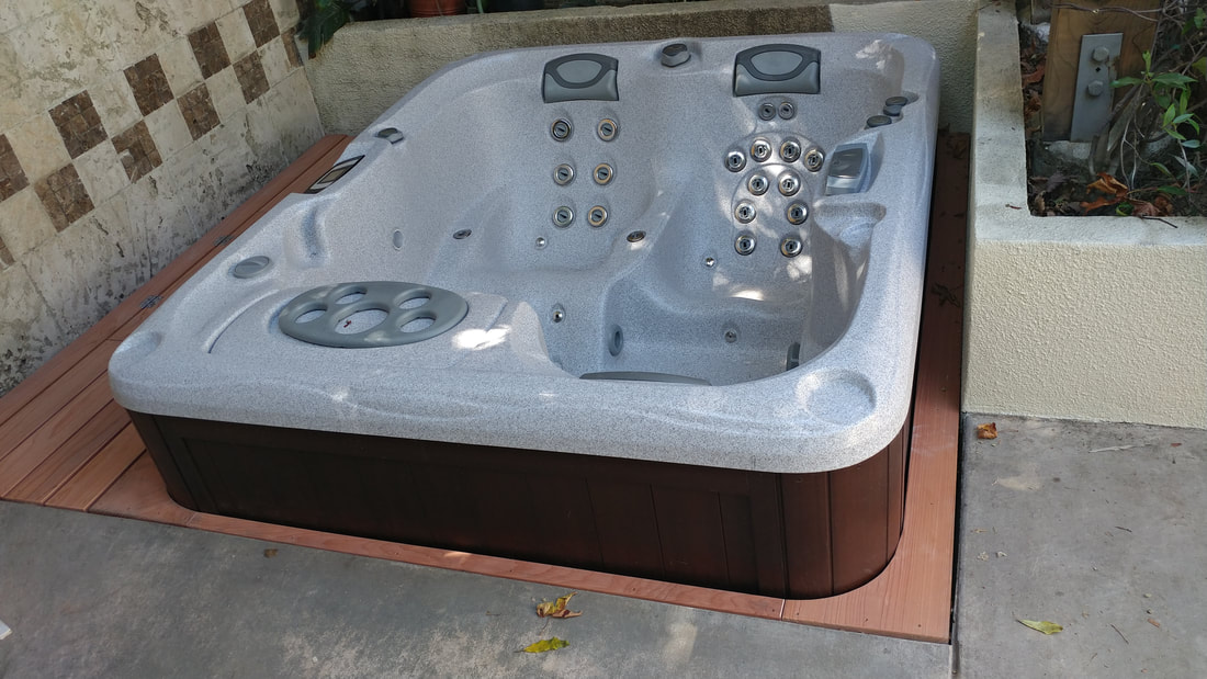  Fancy new hot tub gets custom fitted deck.
 