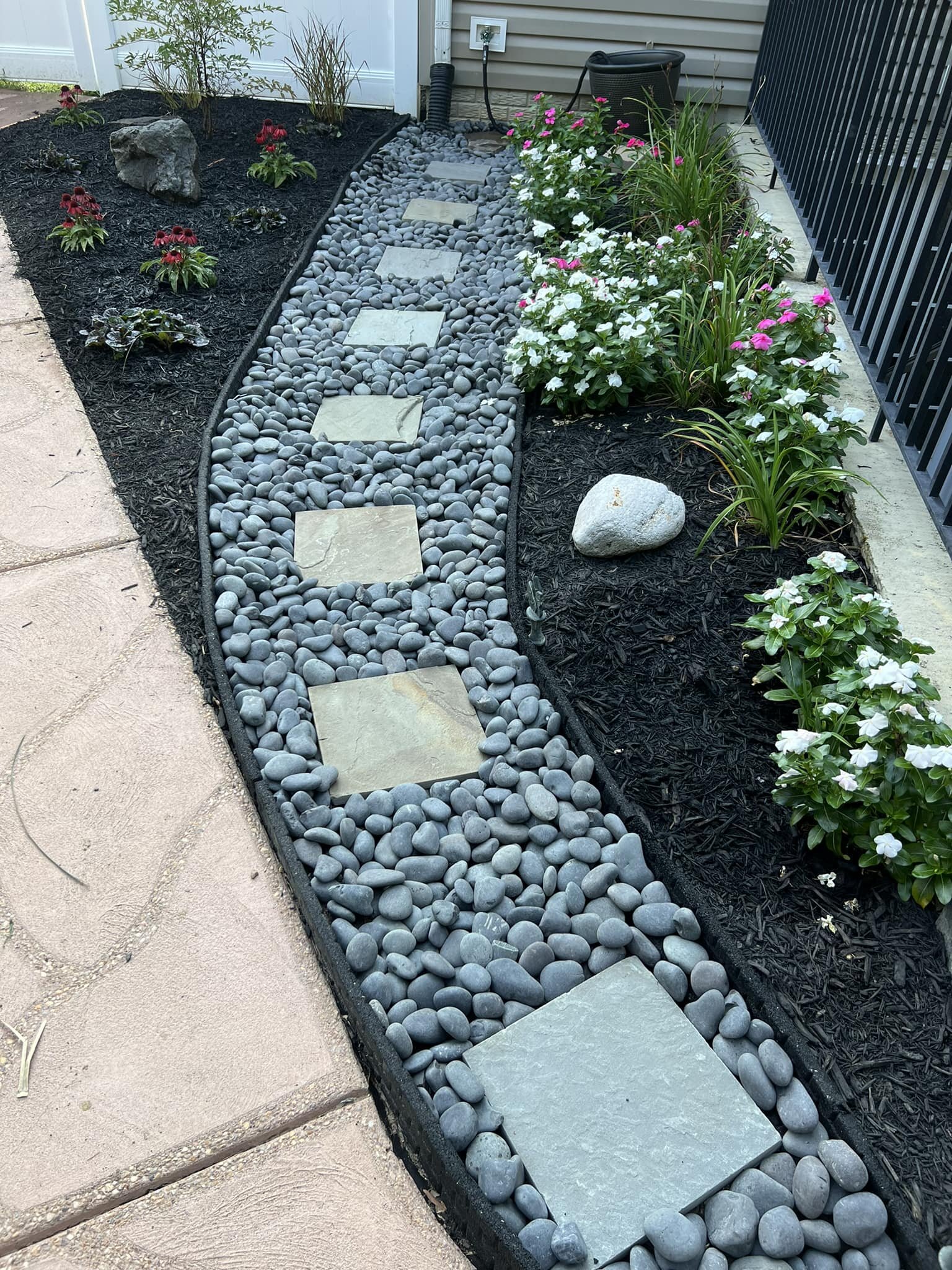 A weekend project! Gray Mexican Beach Pebbles, small stepping stones, Red and White Vinca&rsquo;s,  a Nandina Heavenly Bamboo, Ajuga Black Scallops, Red Coneflowers and a couple of Grasses.