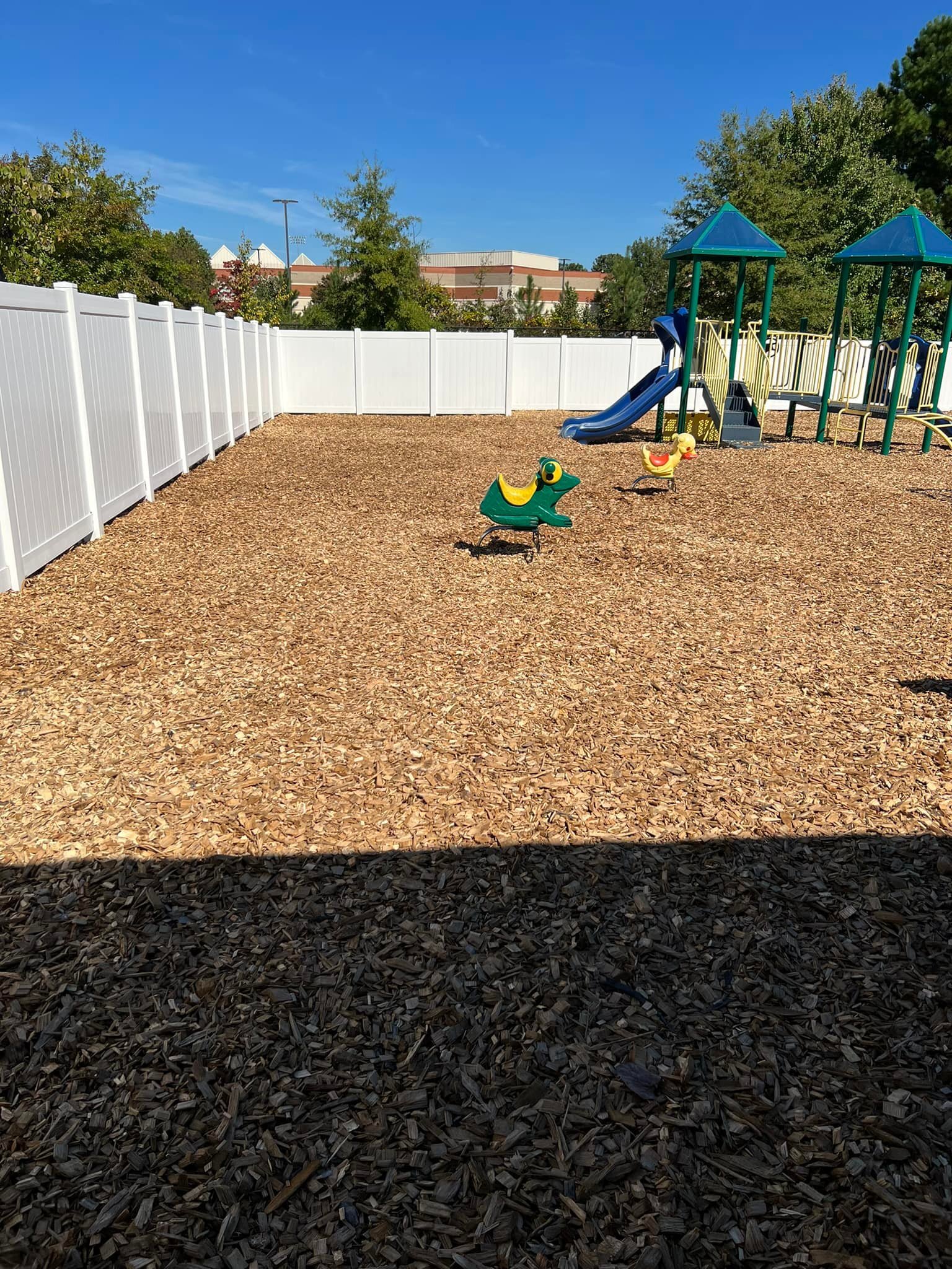 Installation of new wood chips at a Tot Lot.