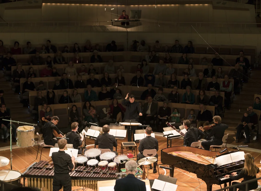 World premiere of the new full production of the complete Babar auf Reisen, presented by the Berliner Philharmoniker in the Kammermusiksaal of the Berlin Philharmonie. Stanley Dodds, conductor and Hans-Jürgen Schatz, narrator (foreground). Photo: Kai Beinert