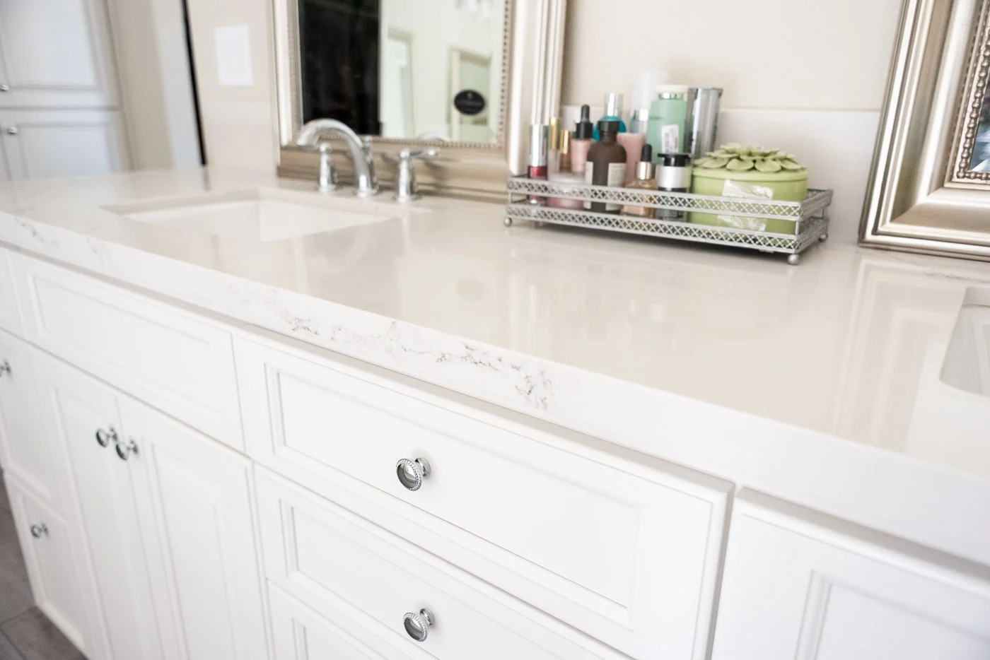 Modern Farmhouse Cottage bathroom vanity with custom white painted cabinets and marble counter tops