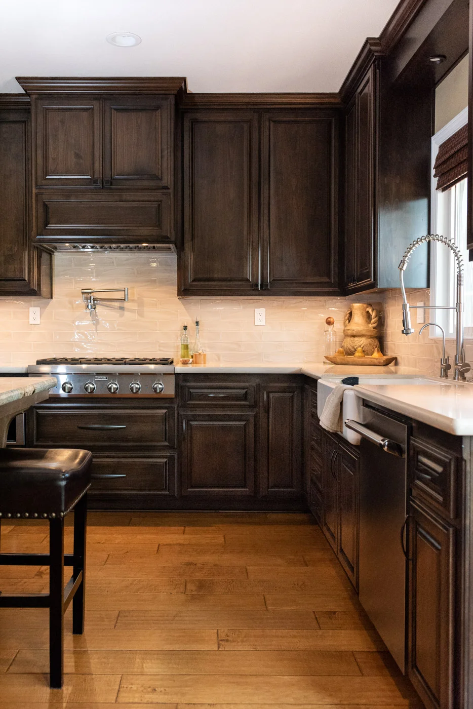 Traditional Mediterranean kitchen with dark wood stain cabinets and custom range hood