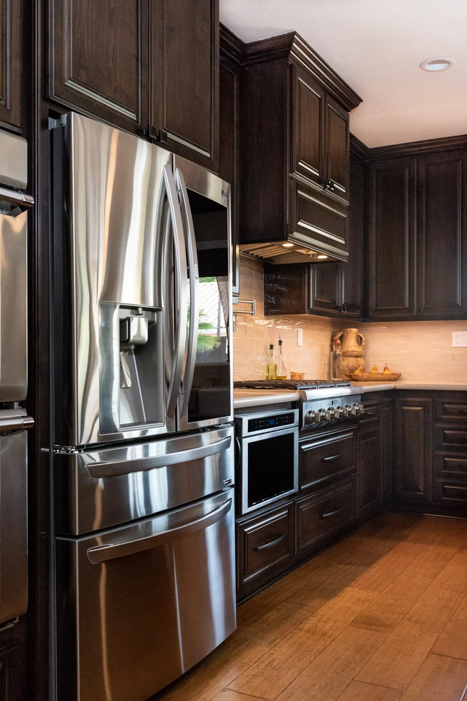 Traditional Mediterranean kitchen with dark wood stain cabinets and stainless steel appliances