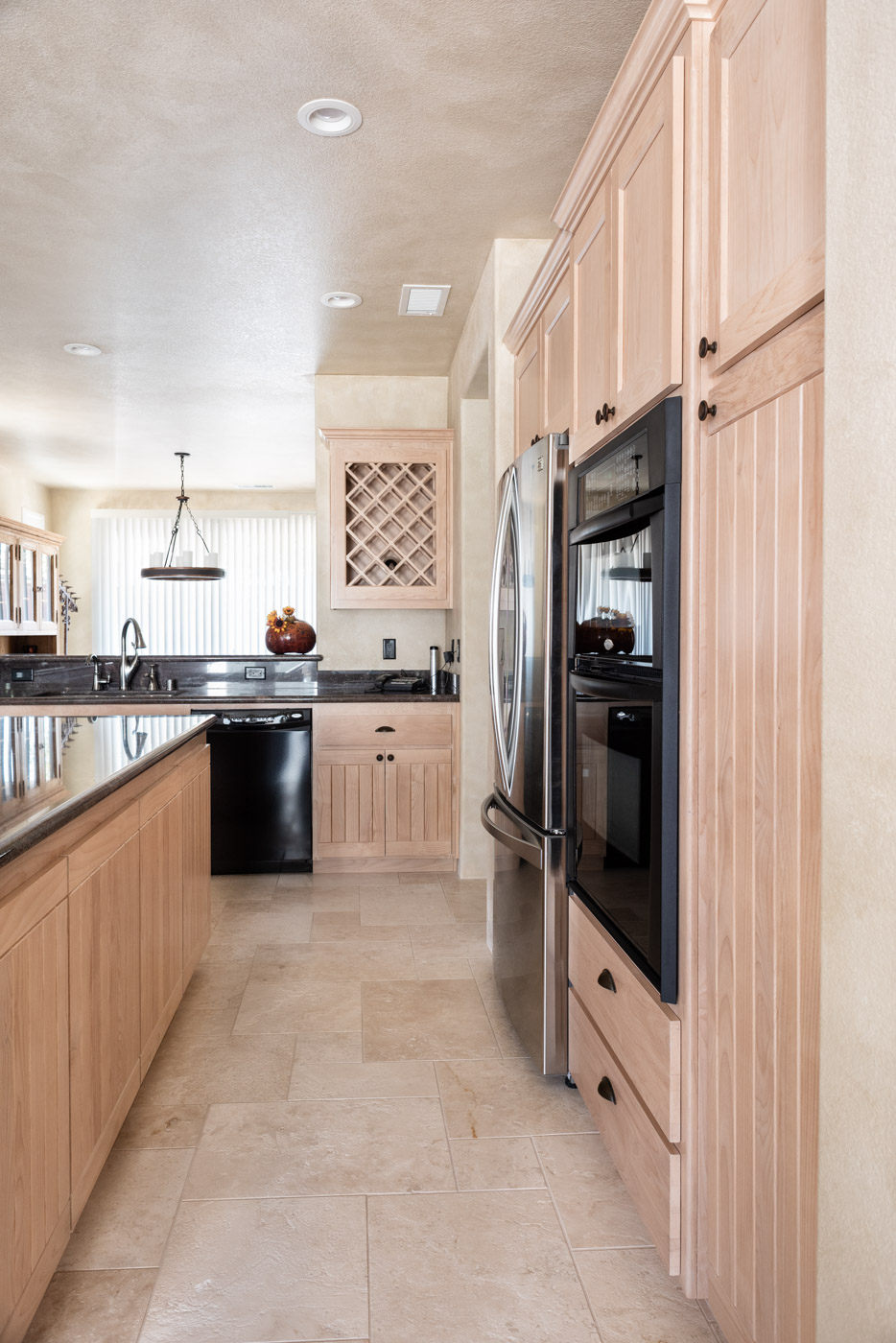 Simple Southwestern custom kitchen cabinets in white washed wood stain