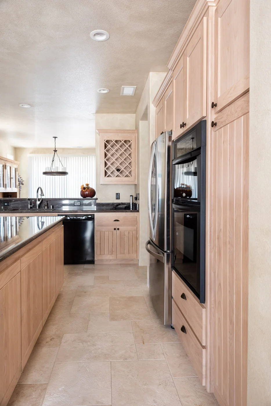 Simple Southwestern custom kitchen cabinets in white washed wood stain