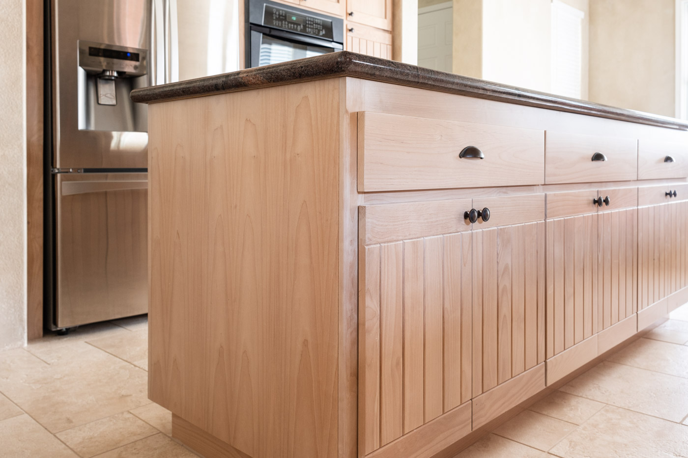 Simple Southwestern custom kitchen cabinets in white washed wood stain