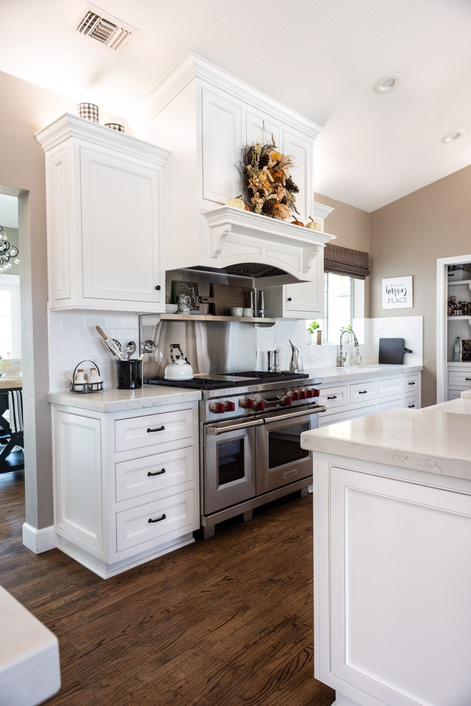 Transitional Country Cottage style kitchen with white recessed panel painted cabinets and custom range hood