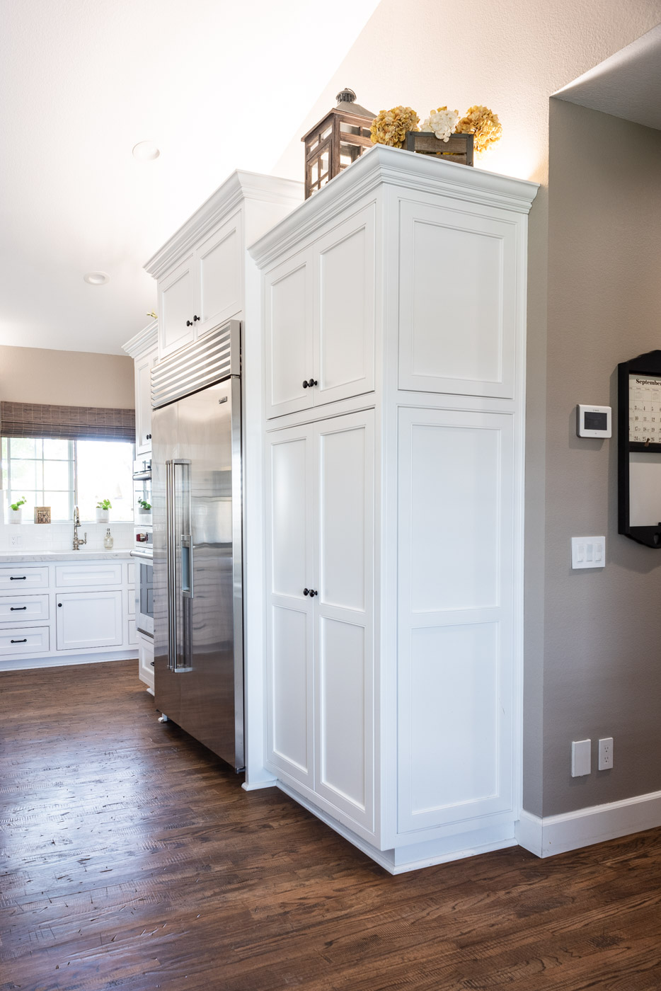 Transitional Country Cottage style kitchen with white recessed panel painted cabinets