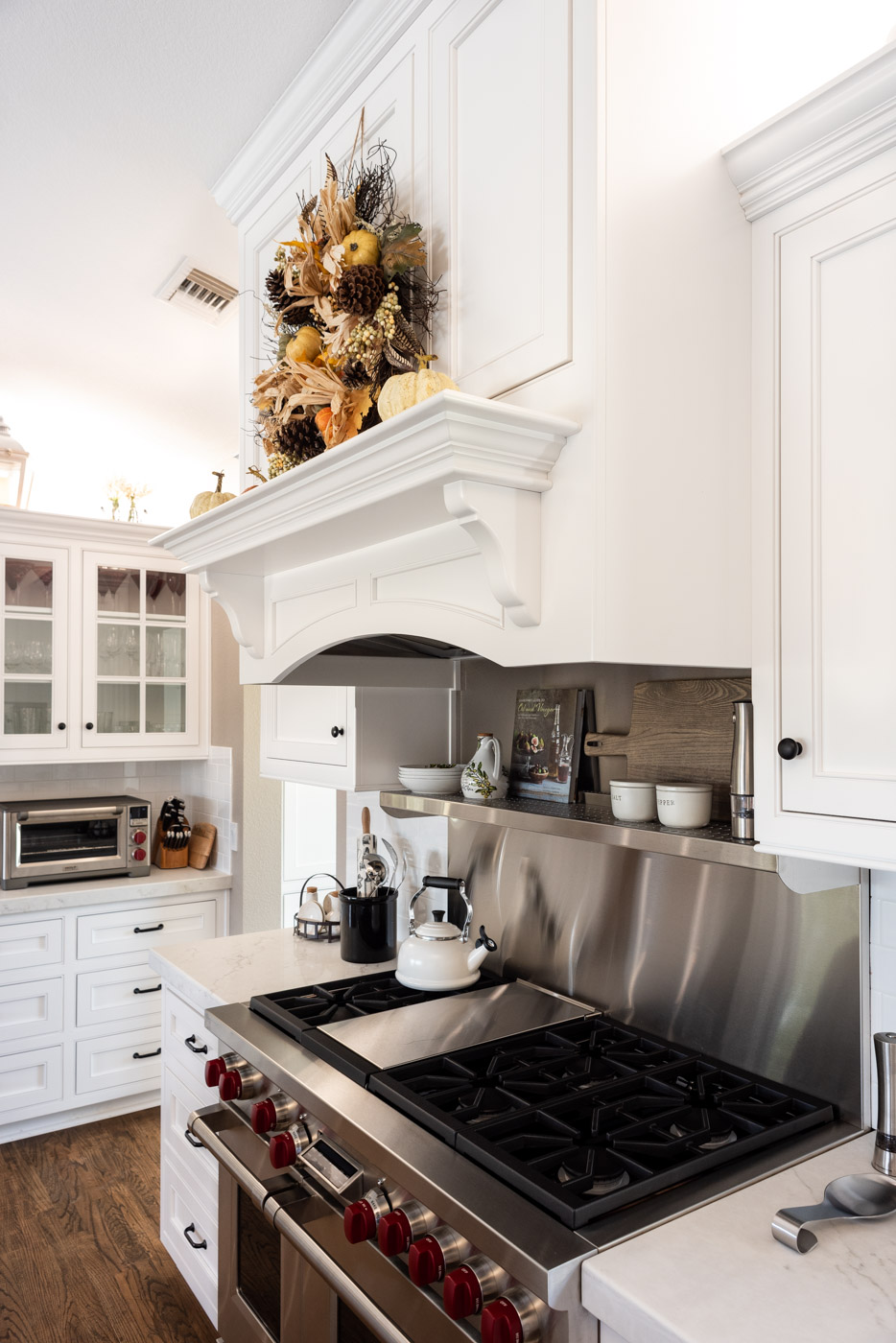 Transitional Country Cottage style kitchen with white recessed panel painted cabinets and custom range hood