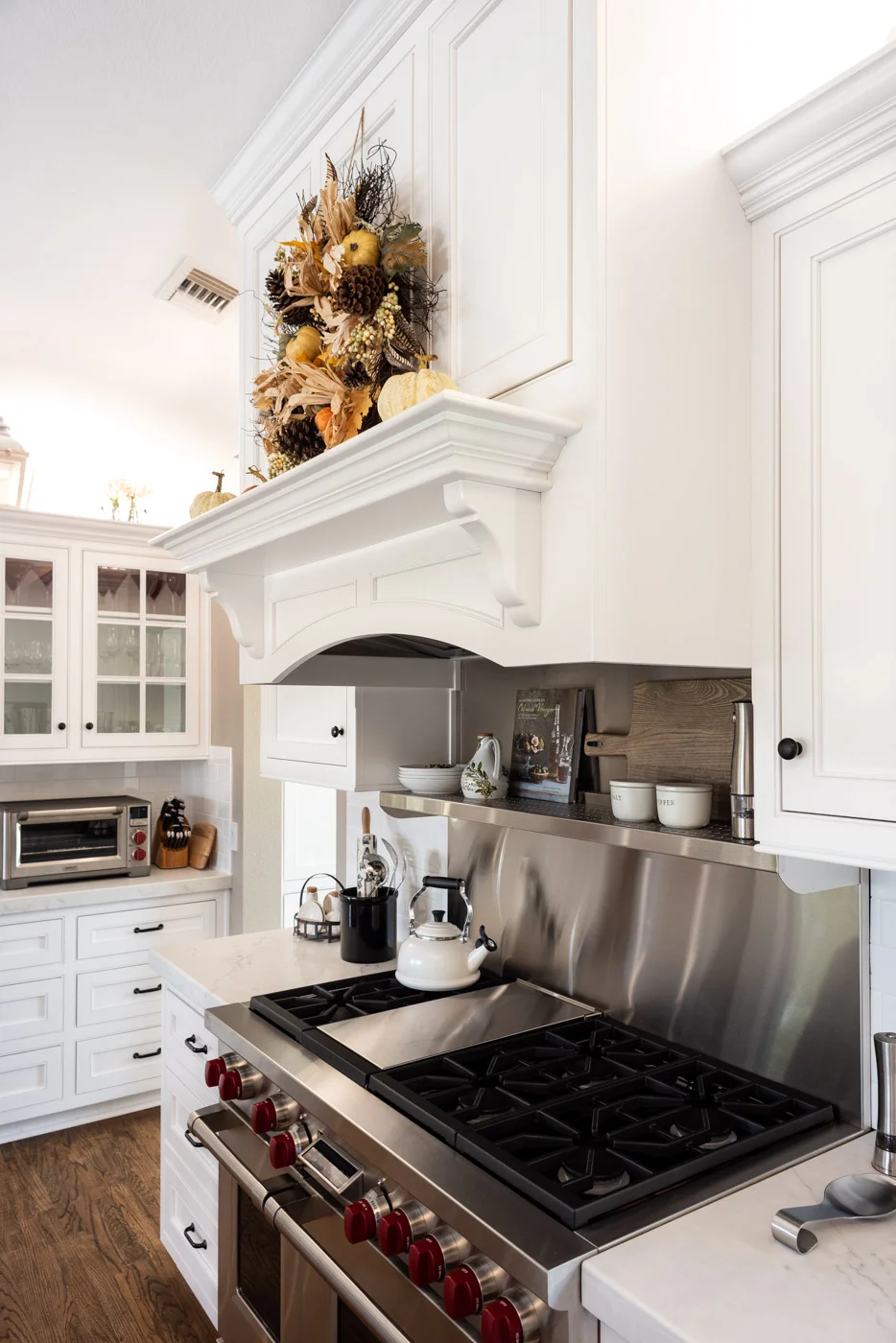 Transitional Country Cottage style kitchen with white recessed panel painted cabinets and custom range hood
