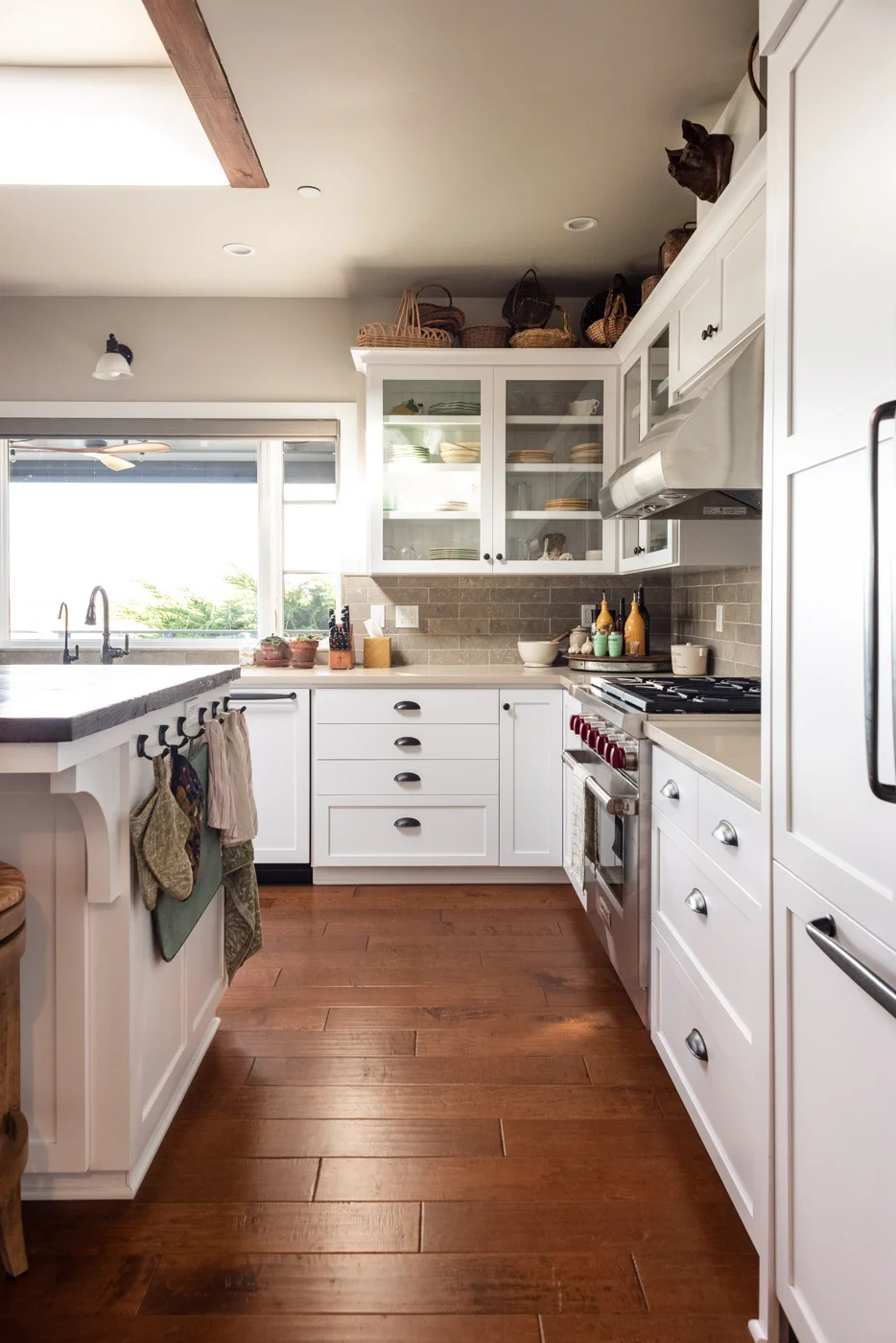 Coastal Craftsman kitchen with custom white painted shaker cabinets