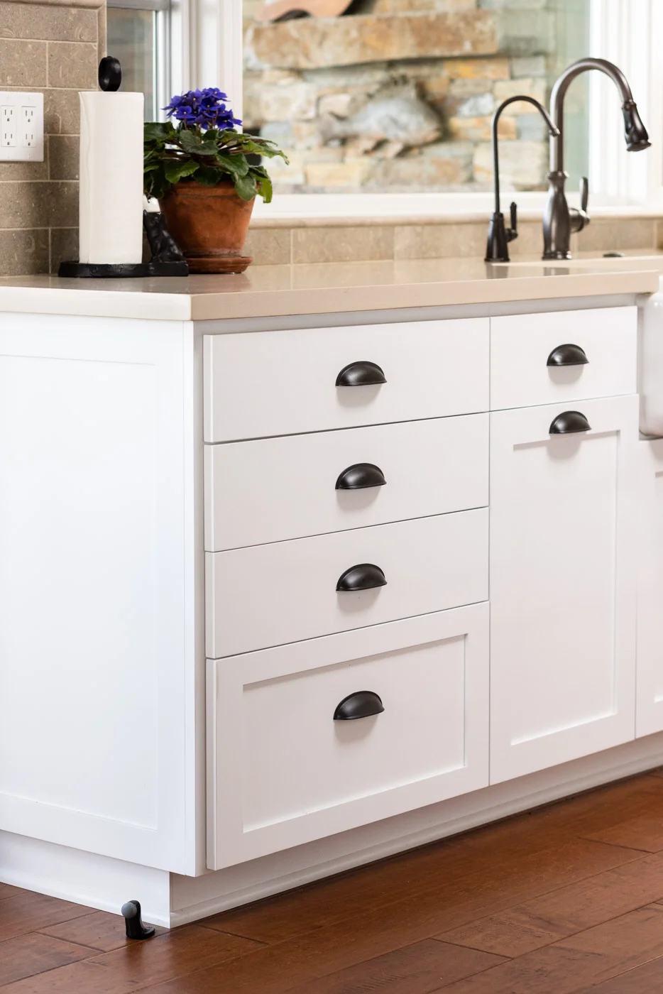 Coastal Craftsman kitchen with custom white painted shaker cabinets