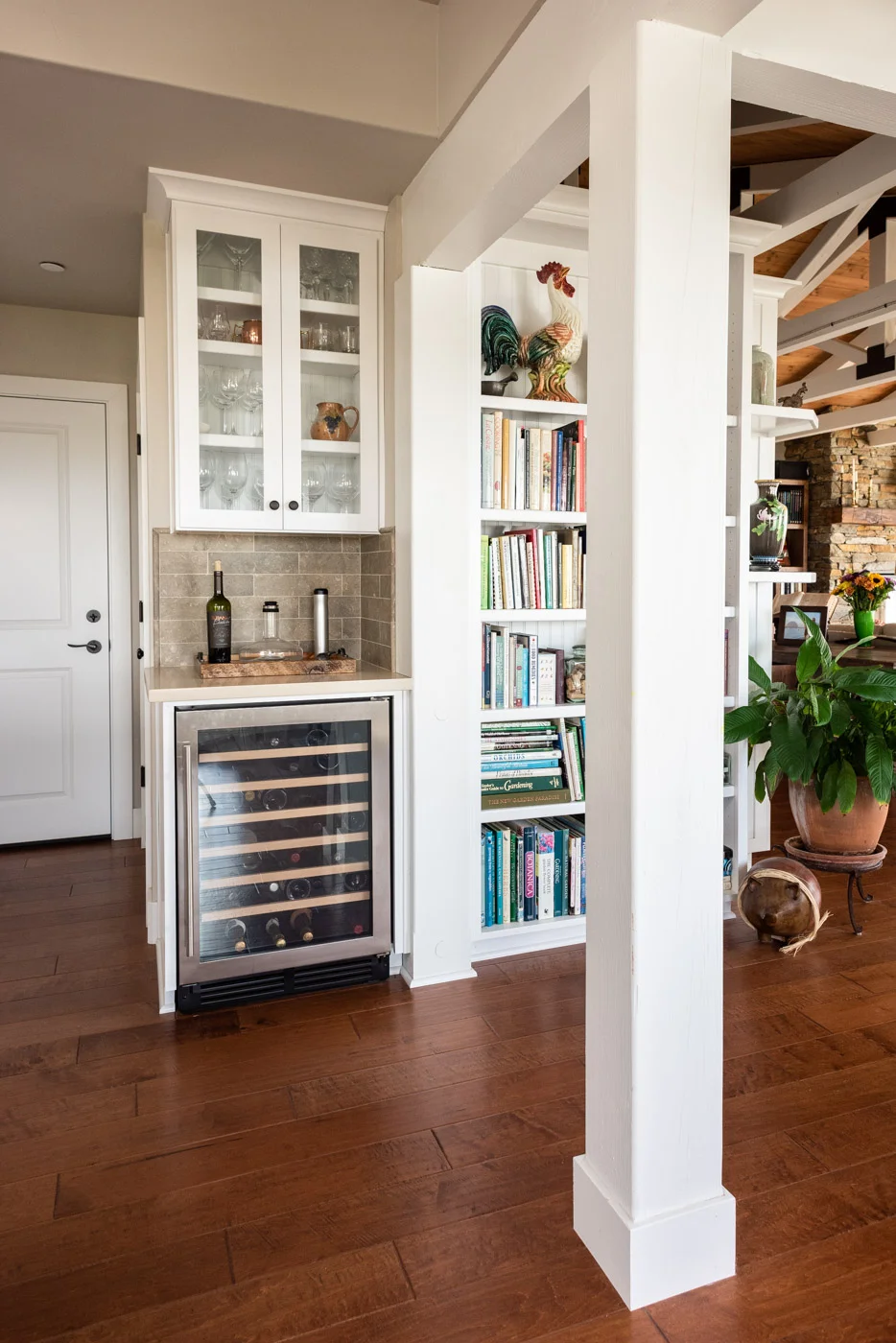 Coastal Craftsman kitchen with custom white painted shaker cabinets and home mini bar