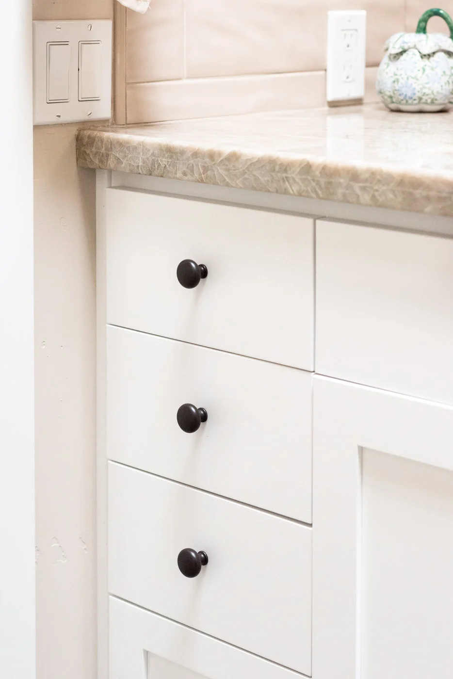 Coastal Craftsman home with custom white painted bathroom vanity cabinets