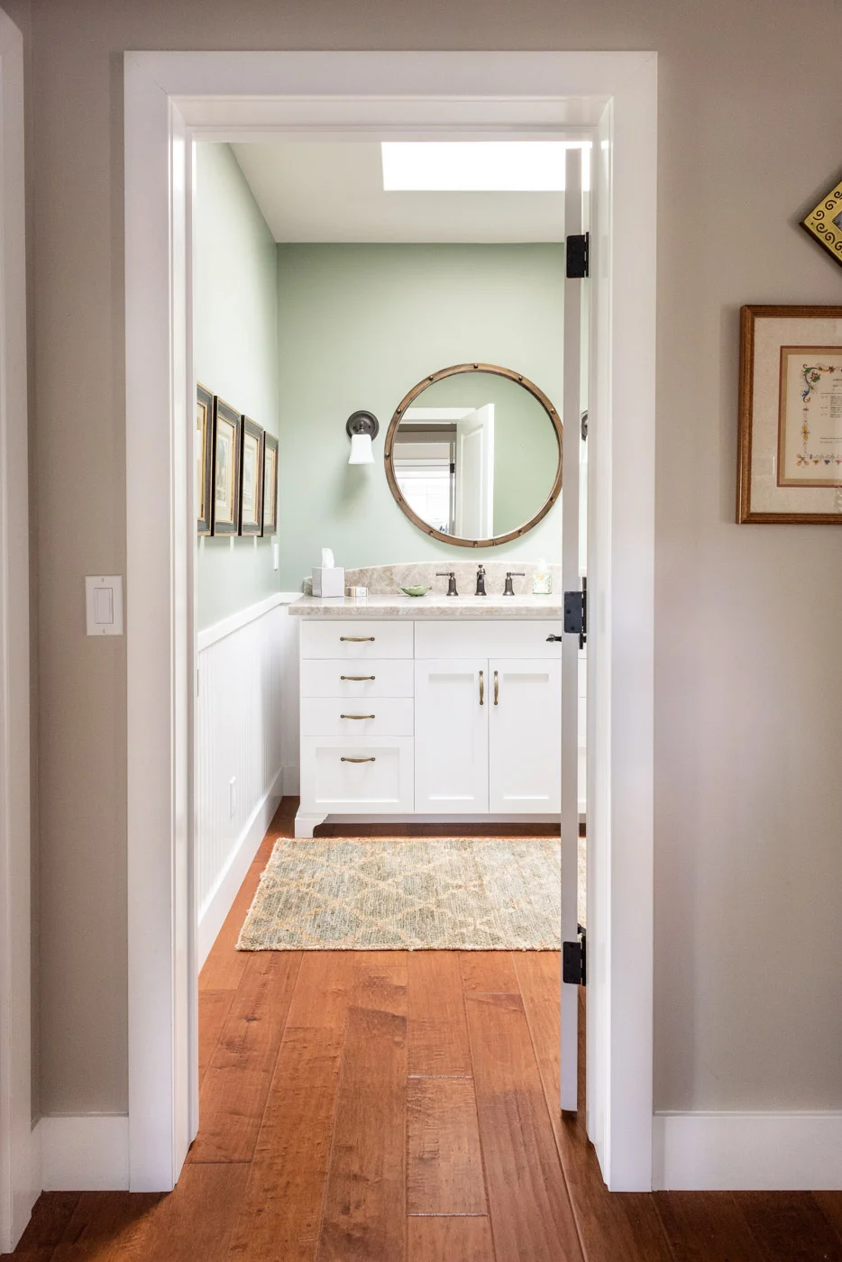 Coastal Craftsman home with custom white painted bathroom vanity cabinets
