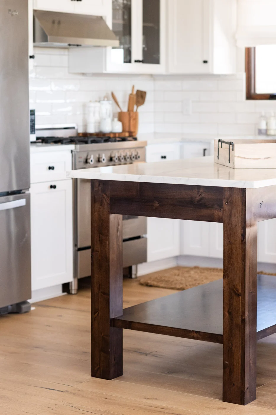 Vineyard Guest House kitchen with custom white painted shaker cabinets and free standing wood island