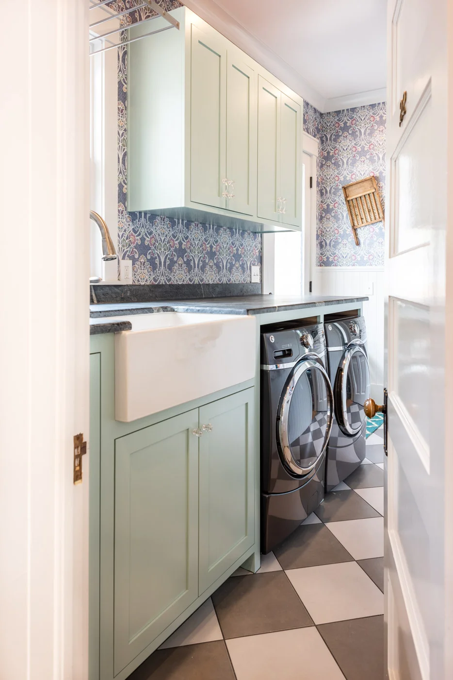 Eclectic Country Craftsman laundry room with custom blue painted cabinets and farmhouse sink