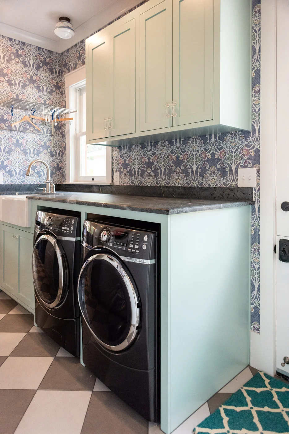 Eclectic Country Craftsman laundry room with custom blue painted cabinets and farmhouse sink