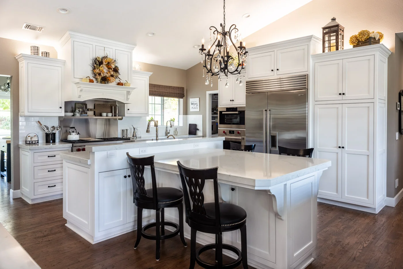 A Transitional white kitchen with custom painted small bone flush inset cabinets and stainless steel appliances