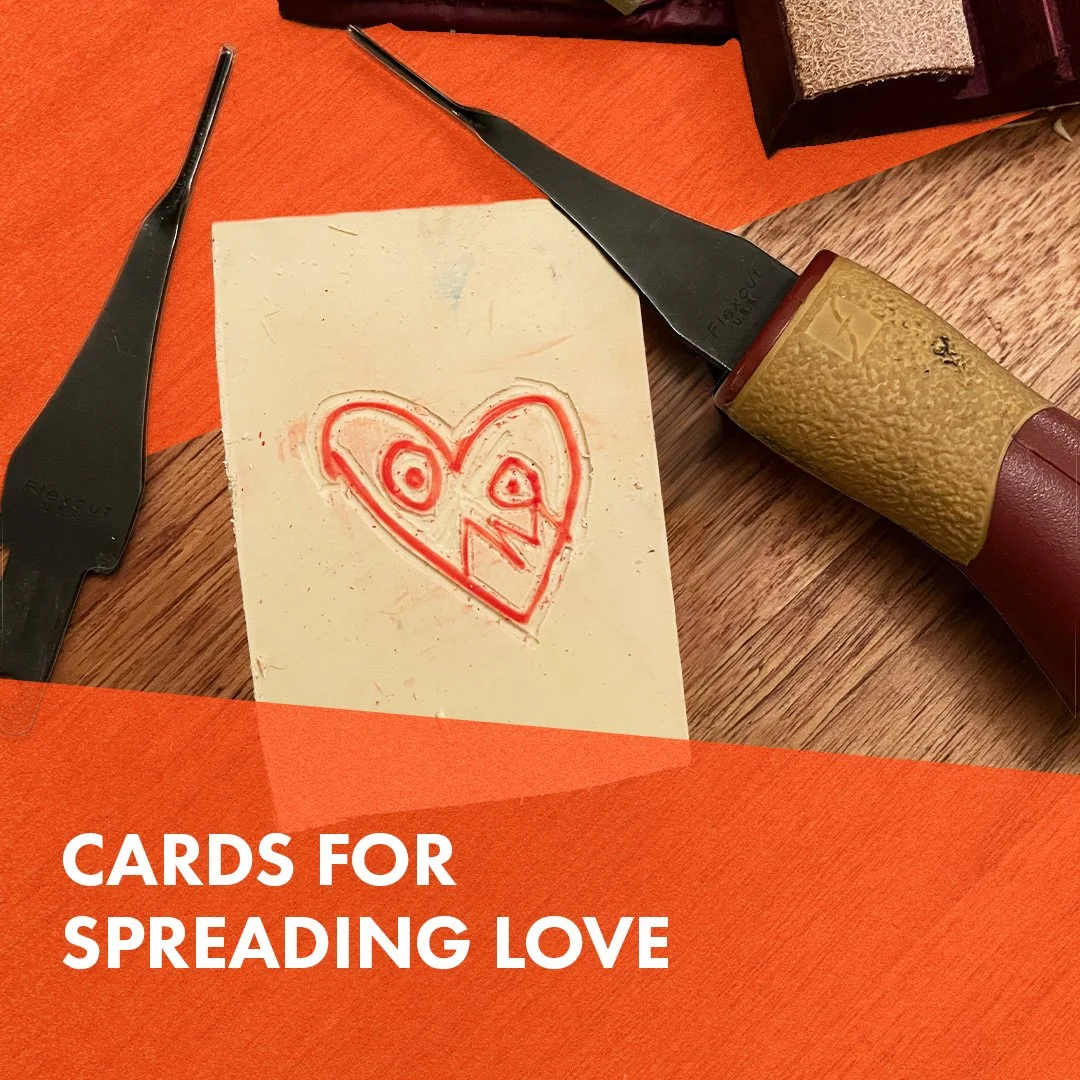 Photo of wooden carving block surrounded by carving tools. Block depicts a red heart with a face. Orange blocks line top and bottom of image with white text overlaid reading 'cards for spreadin (Copy)