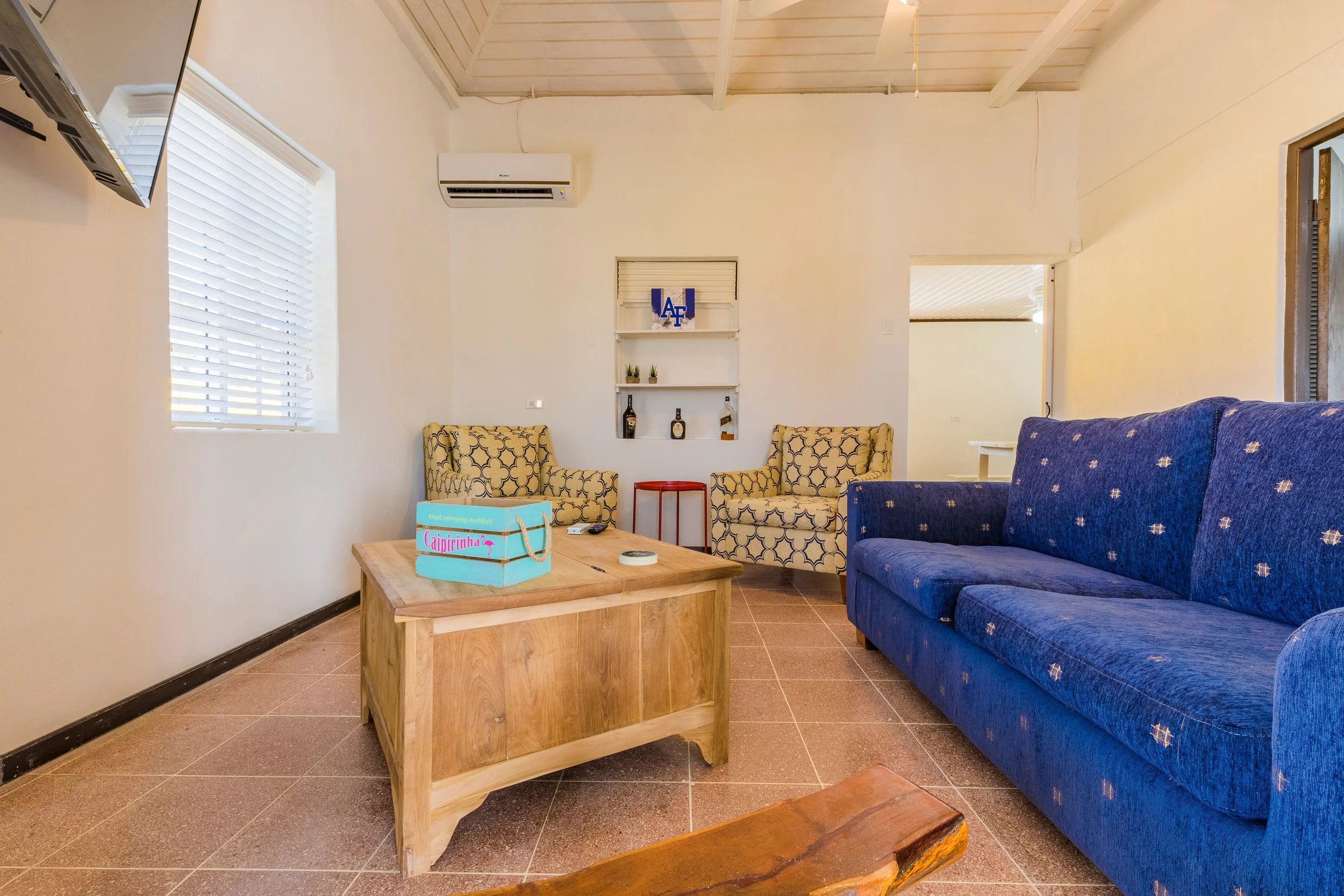 Air-conditioned living room with sofabed and flat screen TV