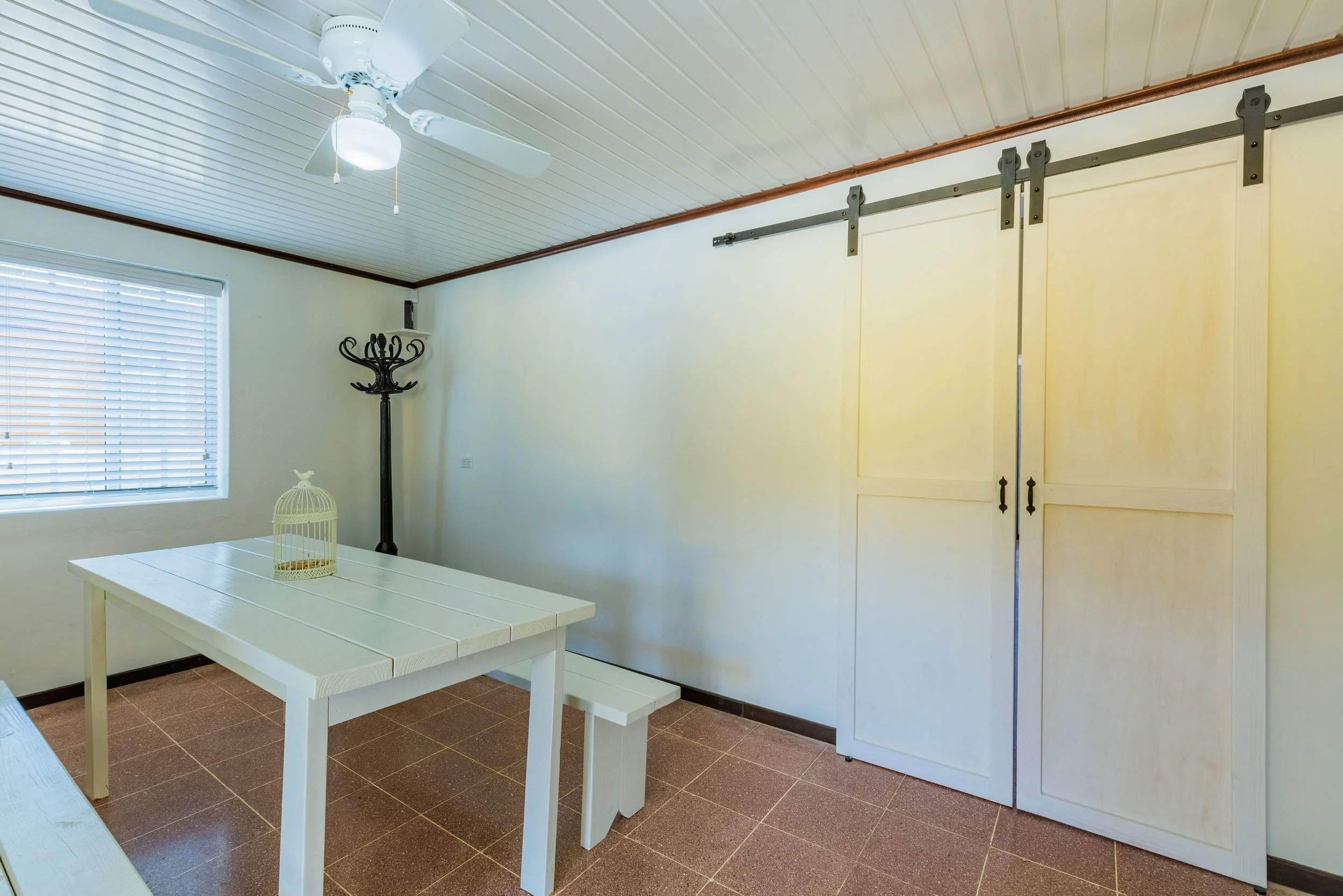 Dining room with farmhouse table and barn doors 
