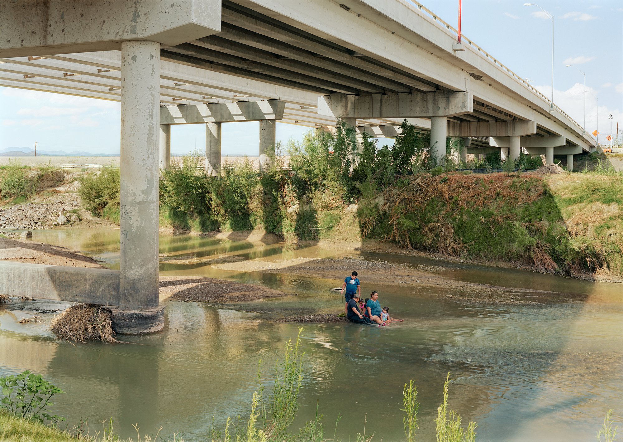Family under the, Presidio-Ojinaga International Bridge, Texas-Mexico border, 2019