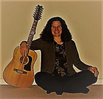 edis sitting guitar brown hue.jpg