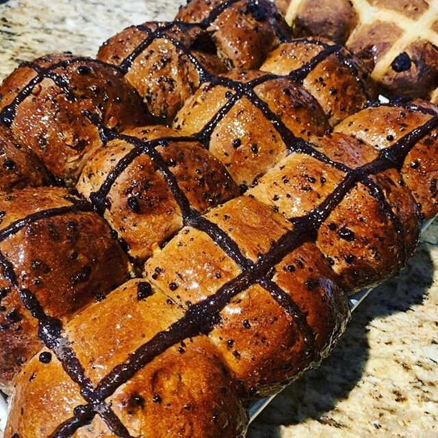 Warm sticky soft and choc full of our delicious bean to bar dark chocolate! Our hot cross buns are baked daily and available in dark chocolate or traditional with raisins! @miann_chocolatefactory