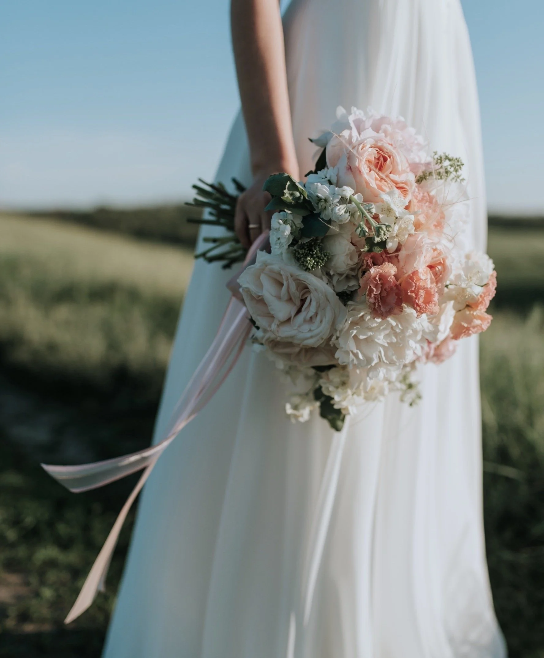 woman-wearing-white-wedding-dress-holding-flower-bouquet-1721944.jpg