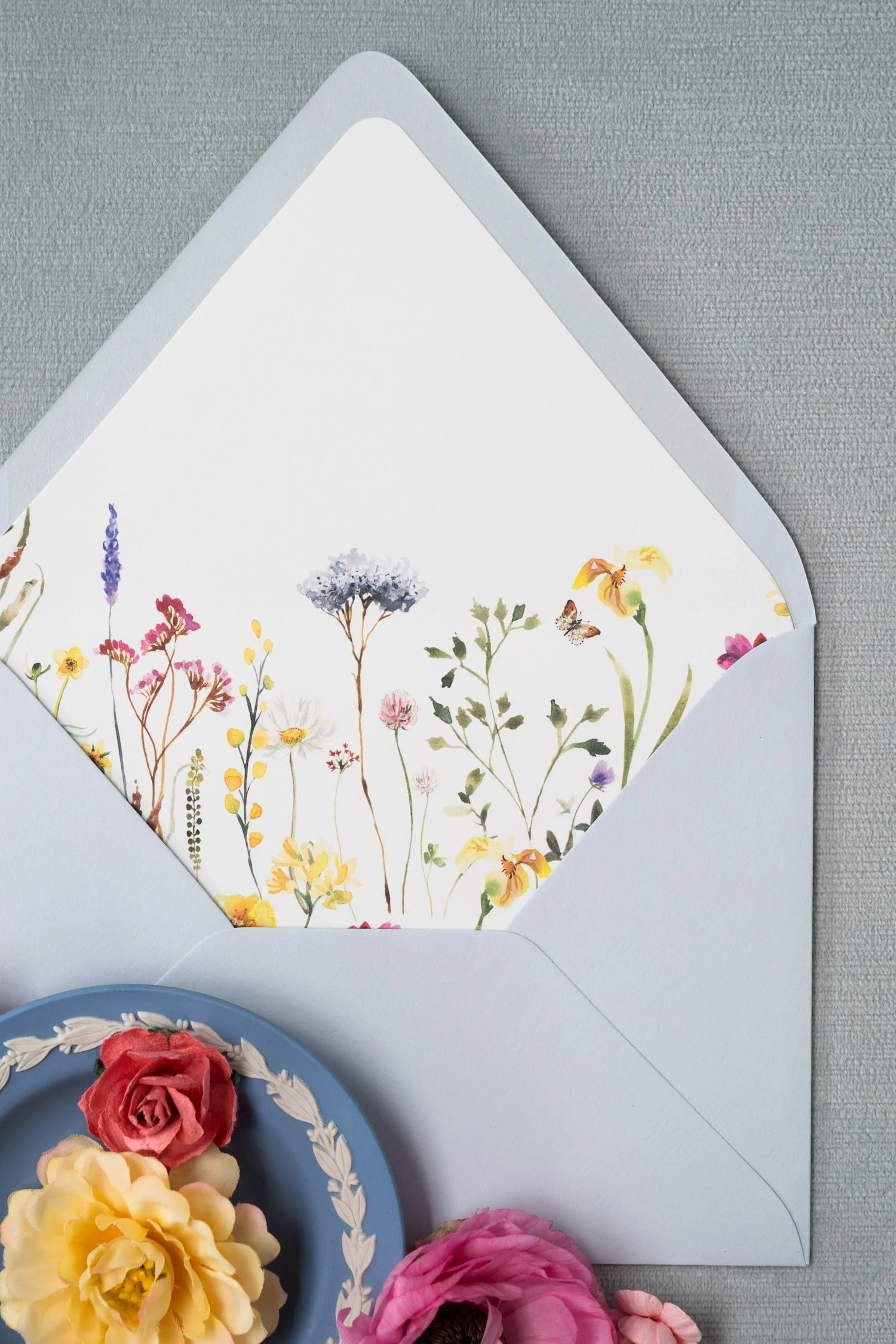 Luxury wedding stationery collection for a Bluemont Vineyard celebration featuring letterpress printing, blind deboss details, floral envelope liners, edge-painted cards, custom oval wax seals, and a bespoke floral crest.