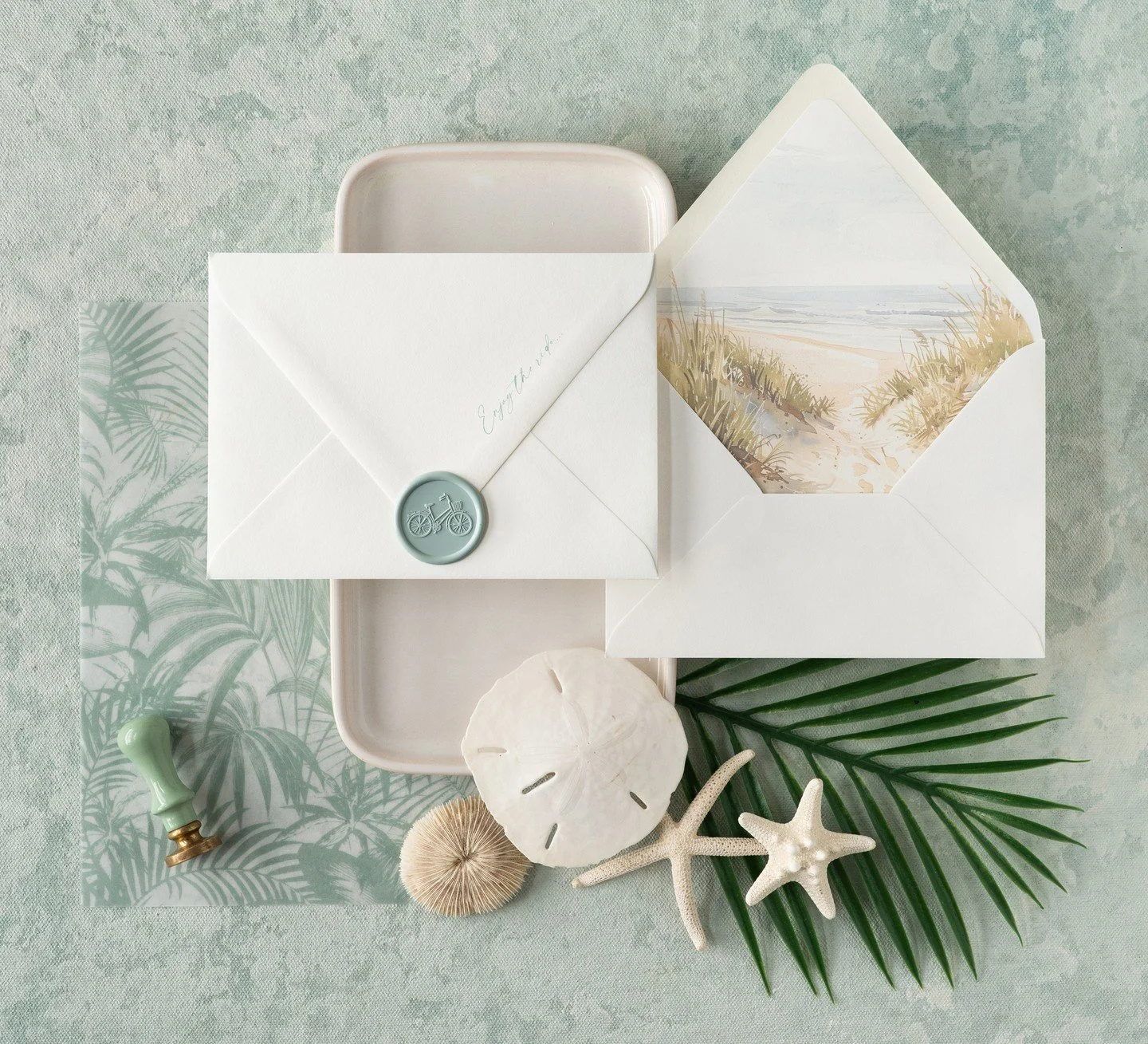This suite was made for sandy toes and scenic routes &mdash; complete with a beachy liner, a wax seal stamped with a bicycle, and a little reminder along the envelope: Enjoy the ride.⁣
⁣
Counting down the days to sun, salt air, and wherever the road 