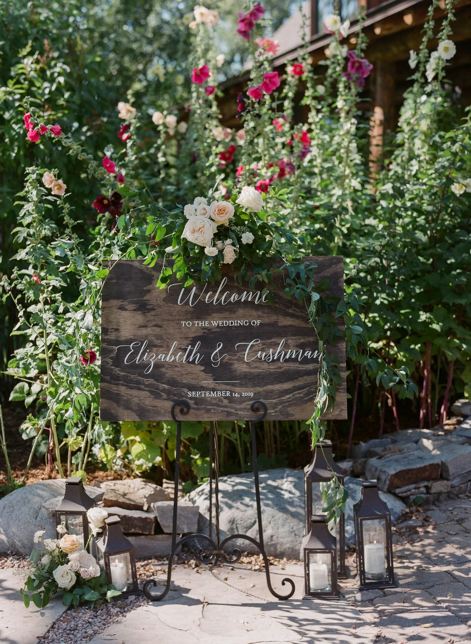 Coordinated wedding day stationery including ceremony programs, acrylic seating chart, signature cocktail signs, menus, place cards, and table numbers for an elegant fall wedding in Steamboat Springs.