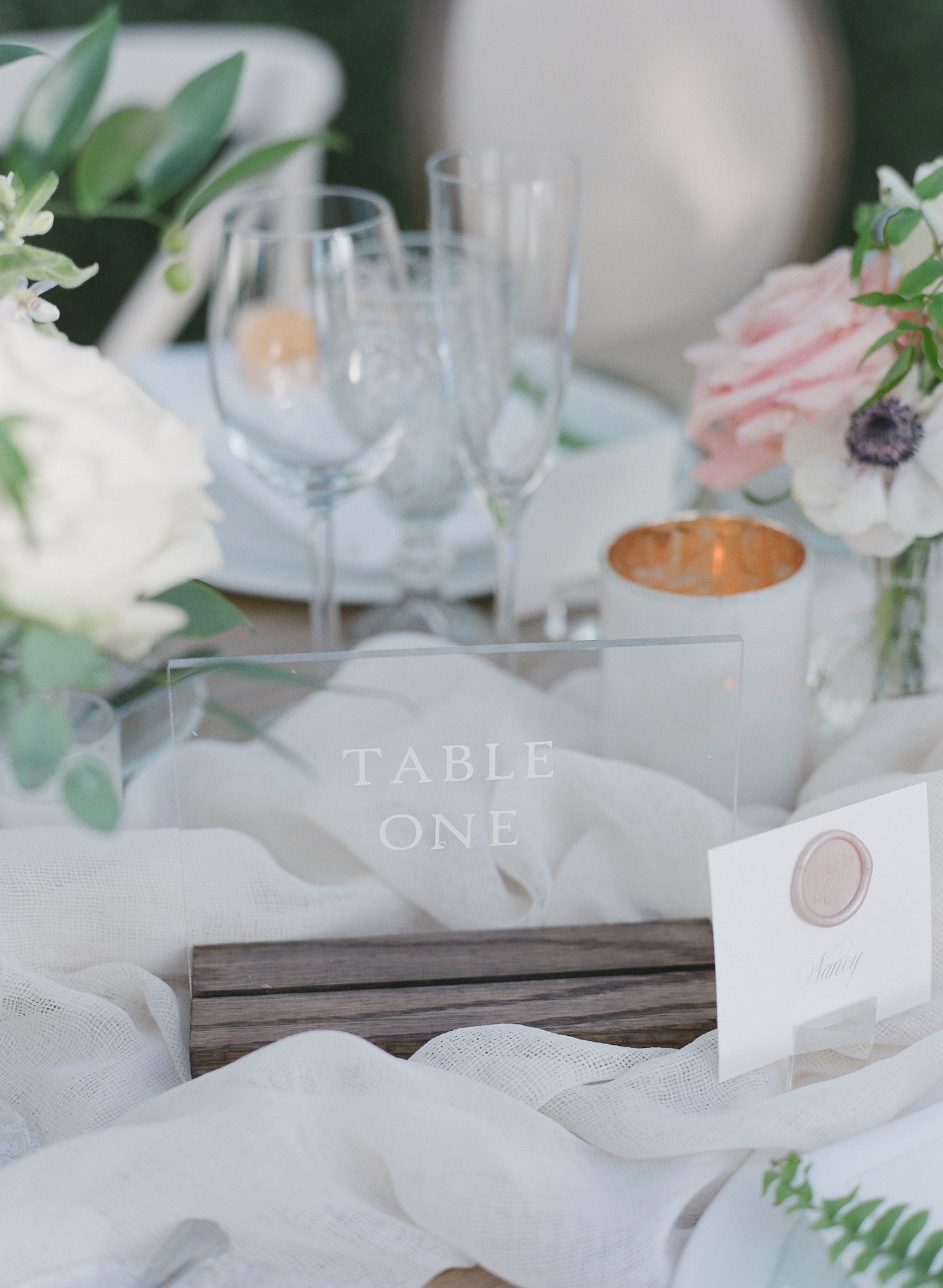 Elegant wedding table numbers designed in coordinating light blue, peach, and white for a luxury fall mountain wedding.