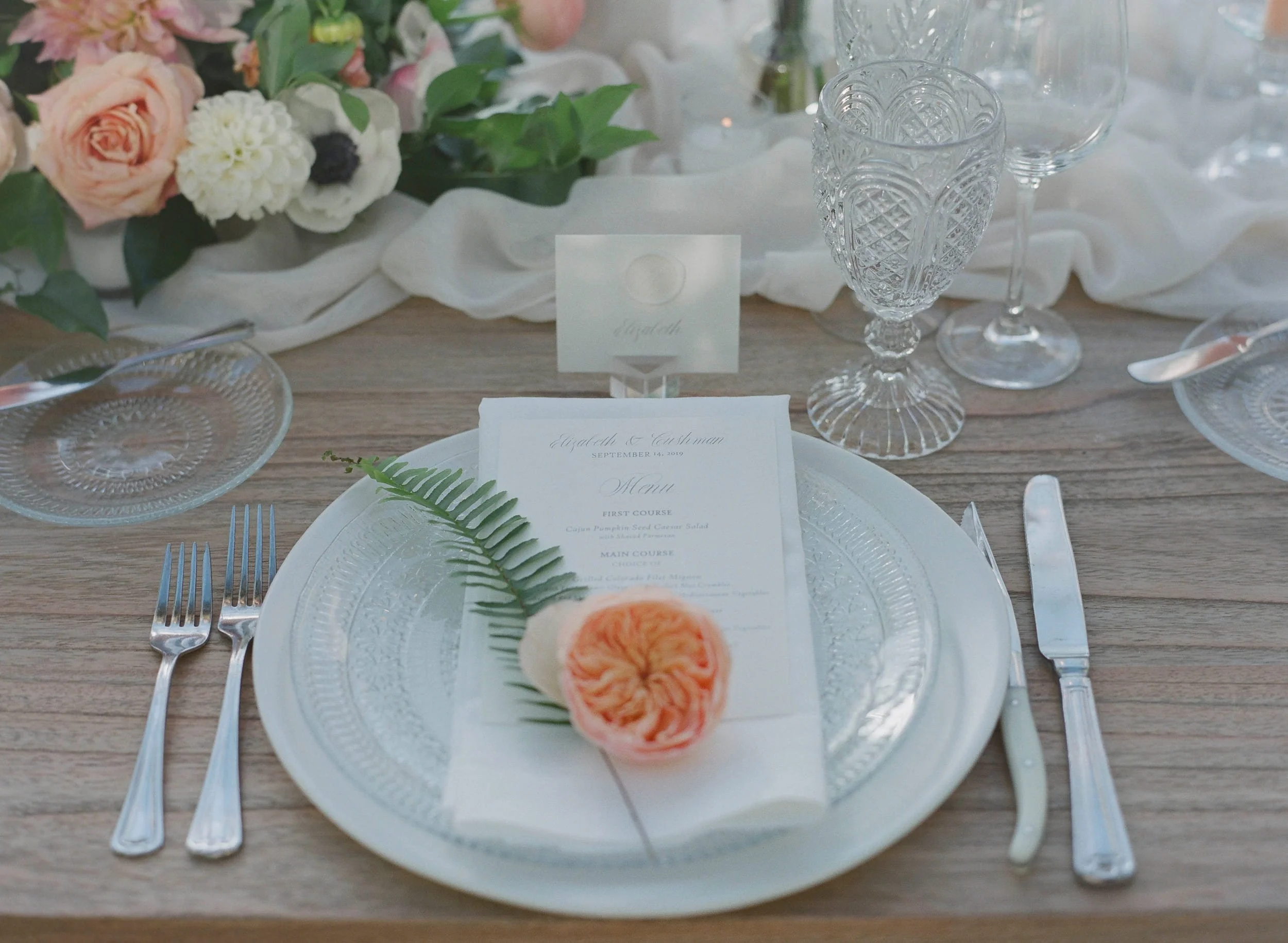 Wedding menus finished with custom wax seals in different colors to indicate guests' meal selections while complementing the overall invitation suite.