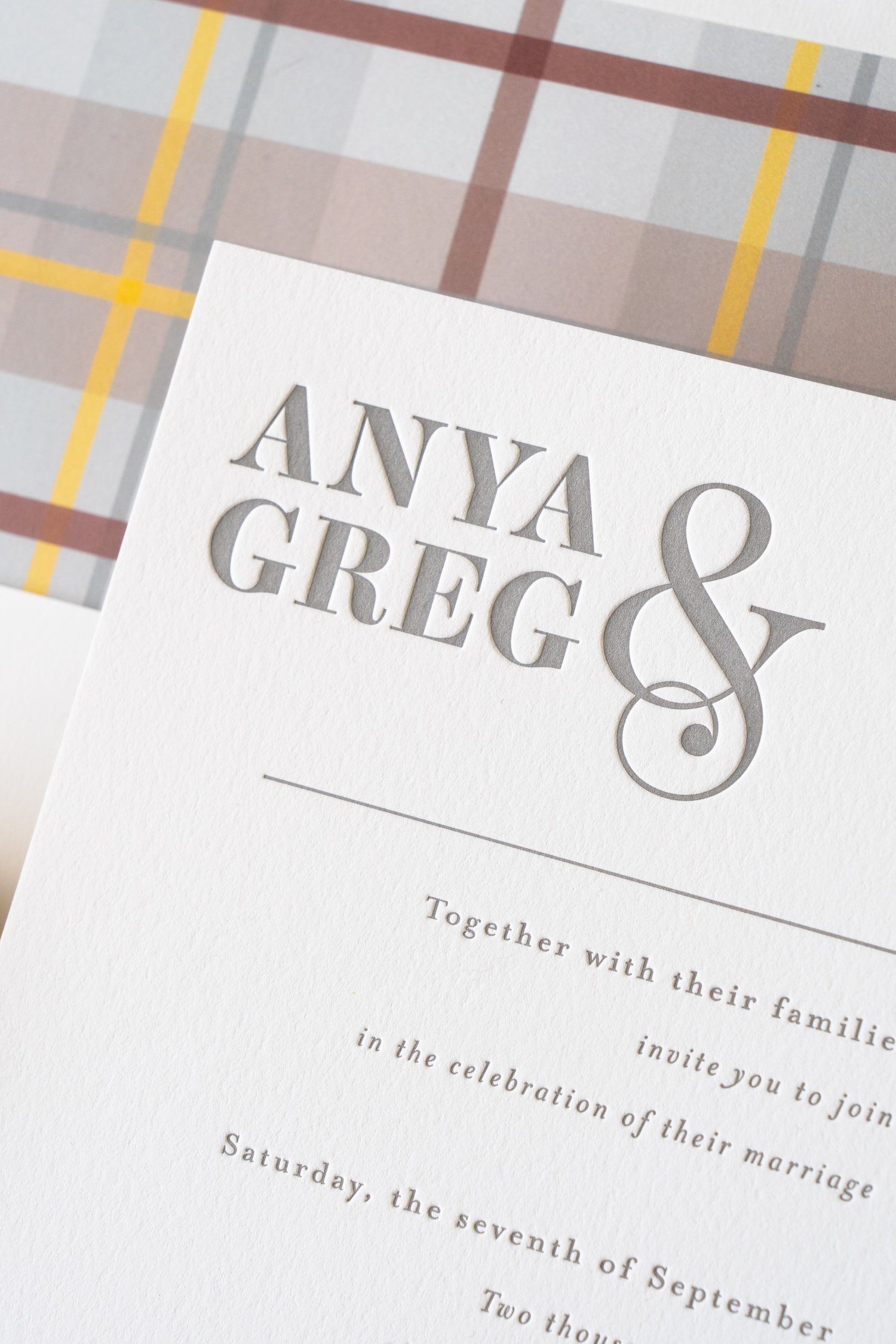 Luxury letterpress and foil wedding invitation suite for a September wedding at Kimpton Hotel Born featuring gray, harvest gold, burgundy, and black-and-white details inspired by the city of Denver.