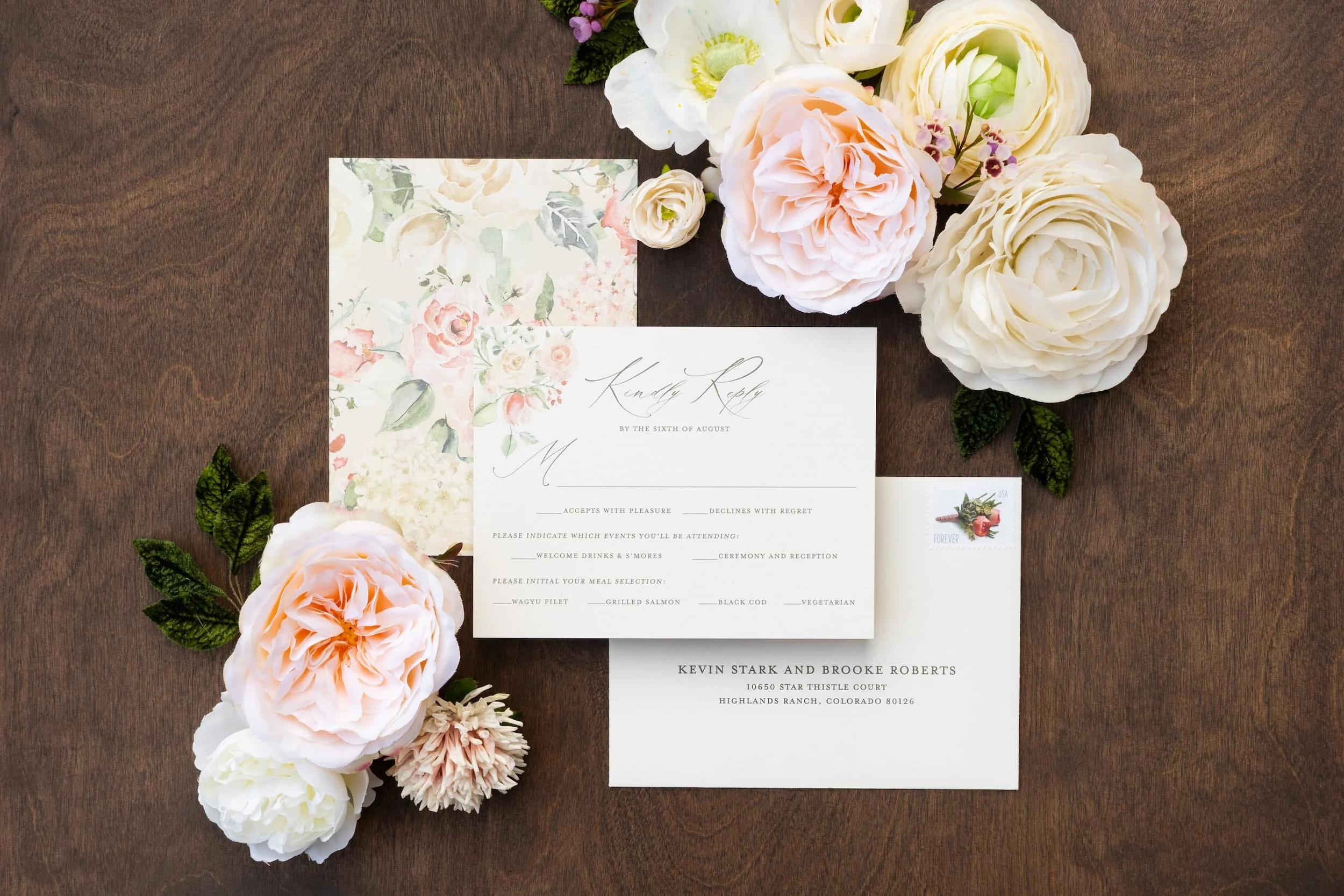 Elegant destination wedding invitation suite featuring watercolor mountain artwork, blush and white flowers, textured paper details, and luxury finishing touches inspired by Aspen, Colorado.
