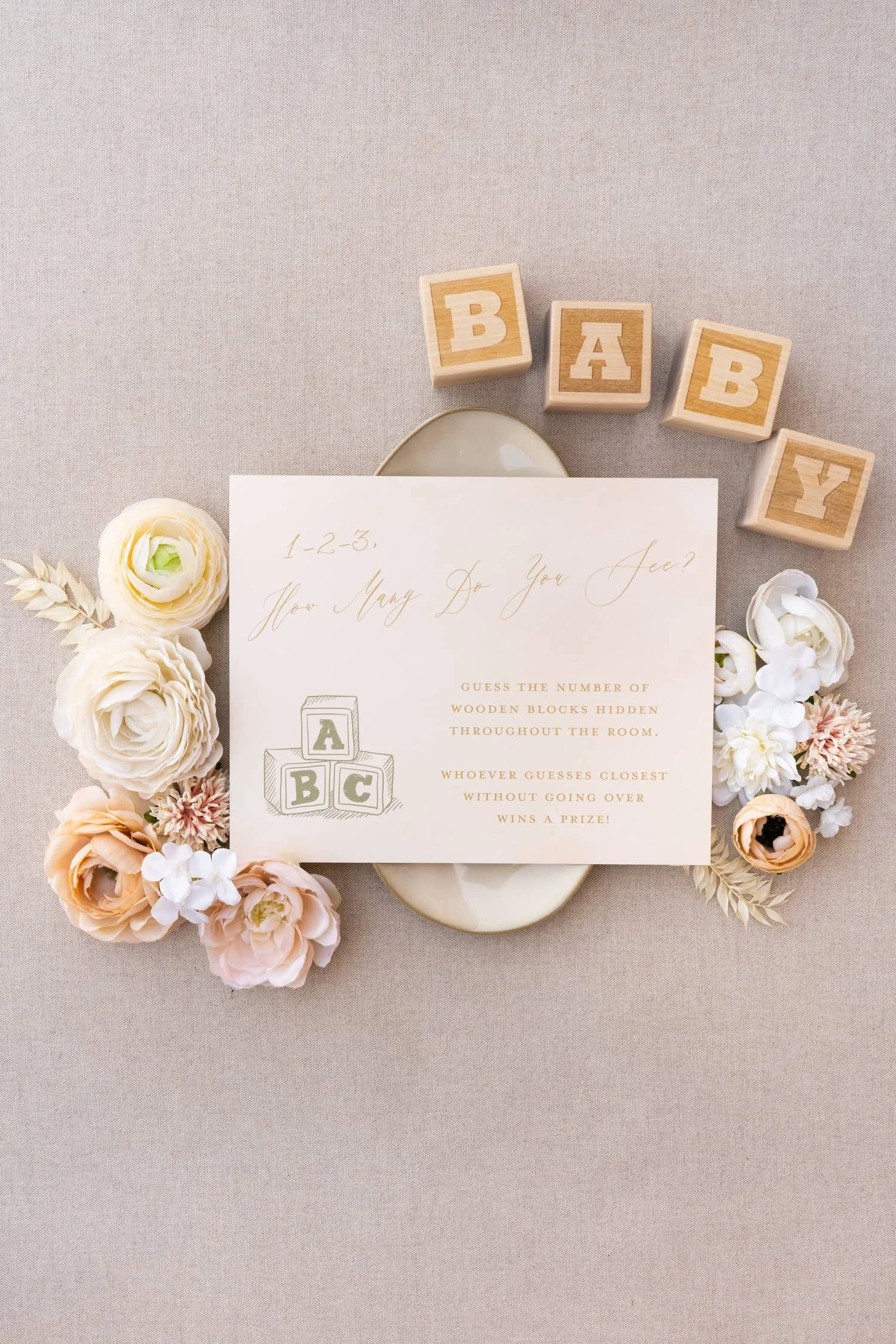 Adventure-themed baby shower games card with warm peach and sage watercolor illustrations and modern typography featuring fun activities for guests during the celebration.