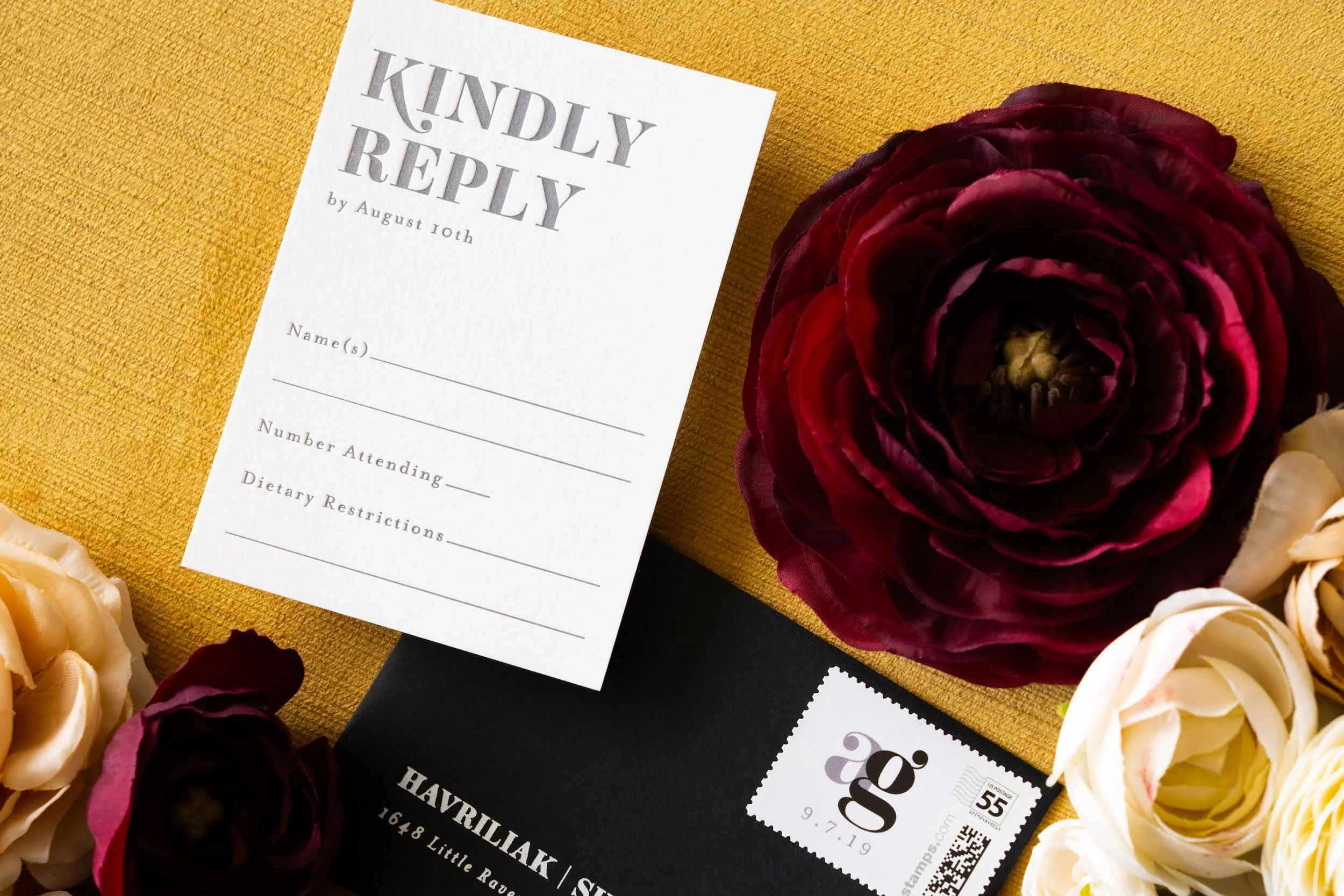 Luxury letterpress and foil wedding invitation suite with reply card and envelope for a September wedding at Kimpton Hotel Born featuring gray, harvest gold, burgundy, and black-and-white details inspired by the city of Denver.