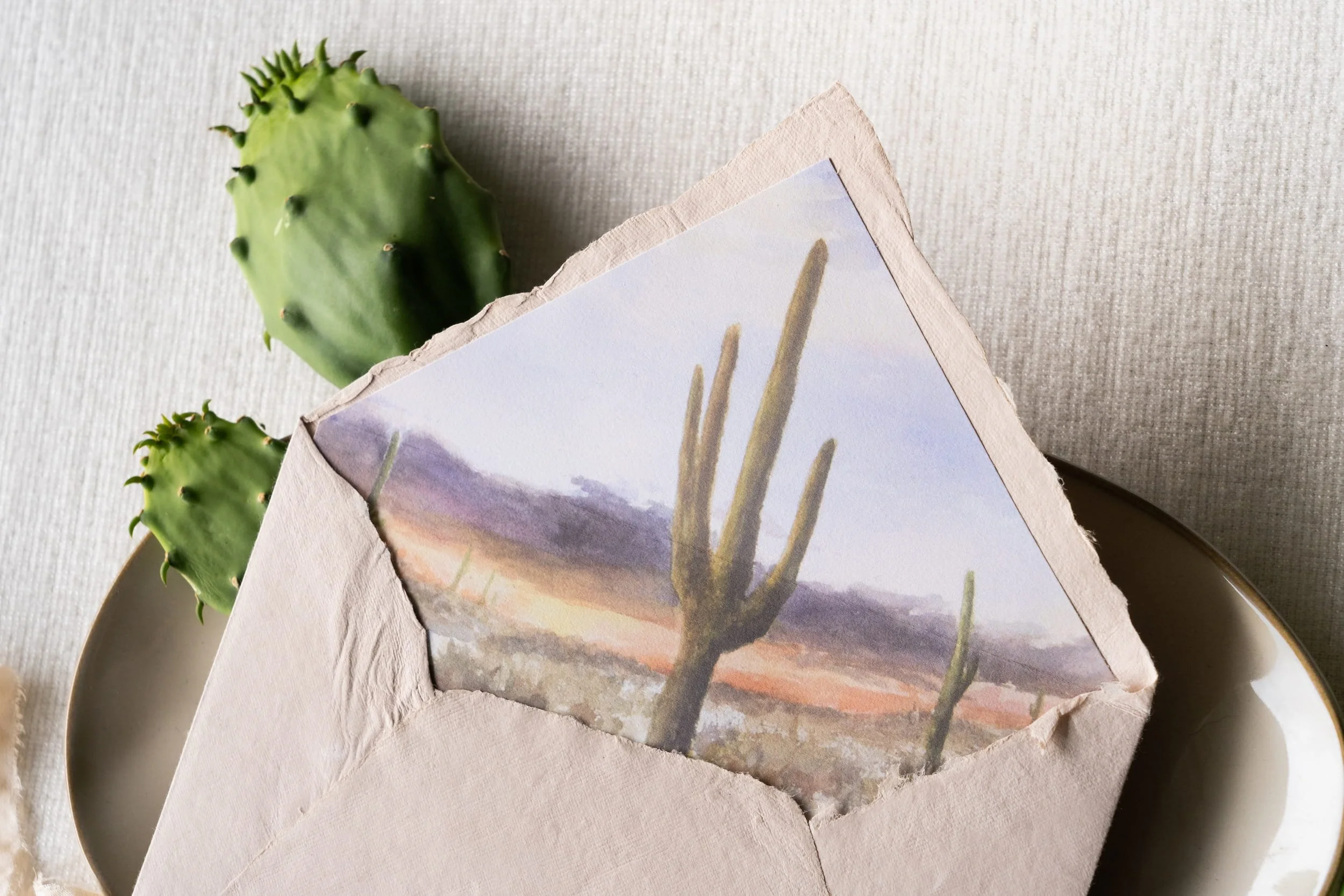 Luxury desert wedding invitation suite letterpressed on handmade paper with a watercolor desert envelope liner for a romantic Four Seasons Resort Scottsdale at Troon North celebration inspired by the Arizona landscape.
