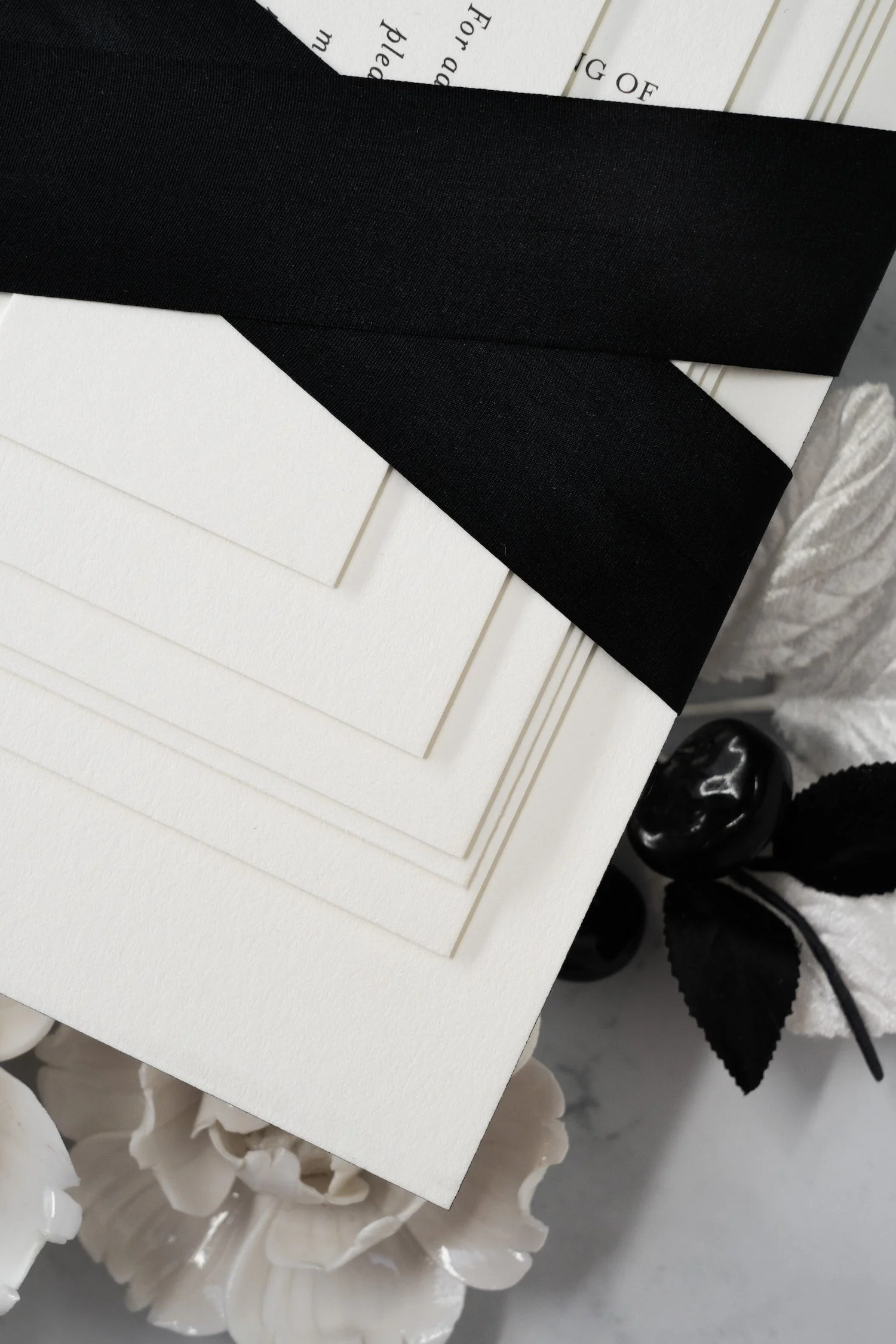 Luxury black-and-white wedding invitation suite with double-thick cotton cardstock, black edge painting, silk ribbon, and vintage postage inspired by old Chicago elegance.